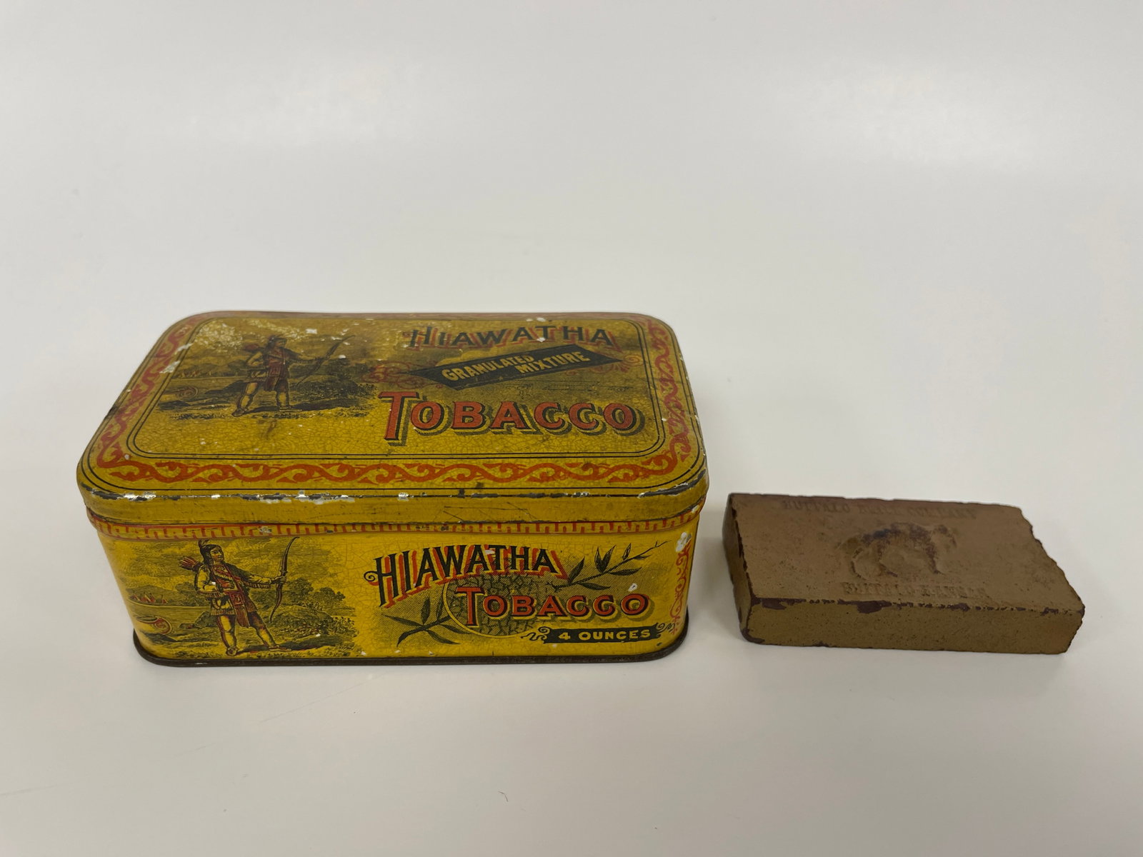 TOBACCO TIN & MINIATURE ADVERTISING BRICK: TOBACCO TIN & MINIATURE ADVERTISING BRICK LATE 19TH C, HIAWATHA TIN & BUFFALO, KANSAS BRICK, EXCELLENT CONDITION.