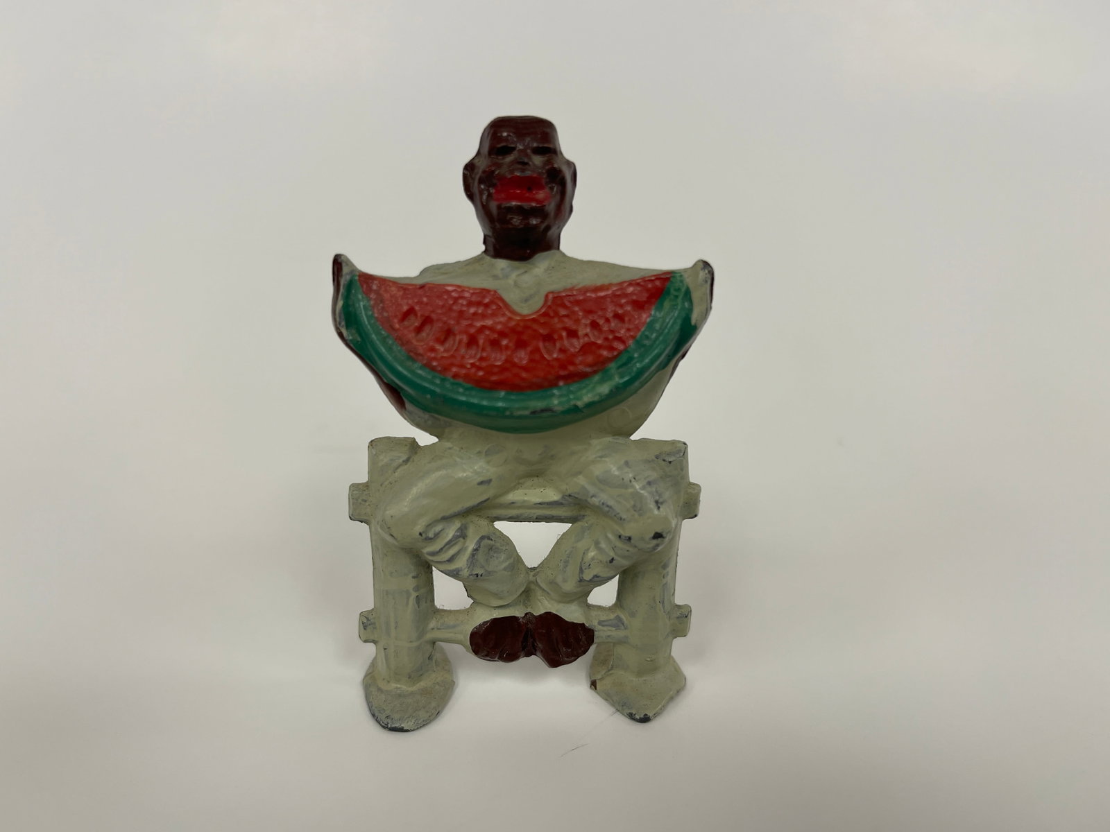 CAST MAN WITH WATERMELON FIGURE (1 of 3)