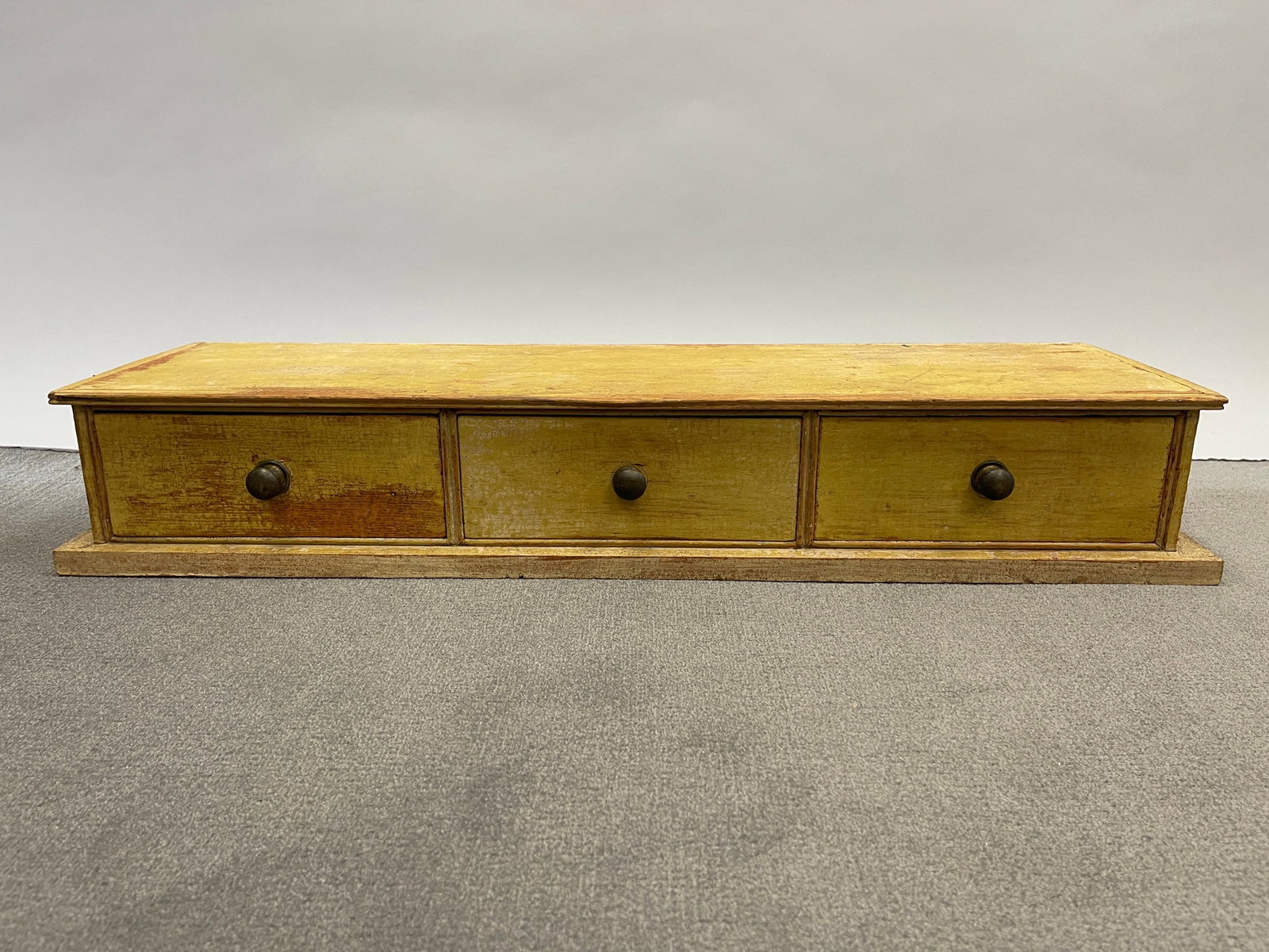 COUNTERTOP SET DRAWERS: COUNTERTOP SET DRAWERS RARE FORM, C 1820, PINE, DOVETAILED DRAWERS, BRASS KNOBS, MOLDED OVERHUNG TOP, OVERHUNG BASE, BEADED DRAWER SURROUNDS. PROFESSIONALLY CLEANED TO DRY ORIGINAL YELLOW PAINT.