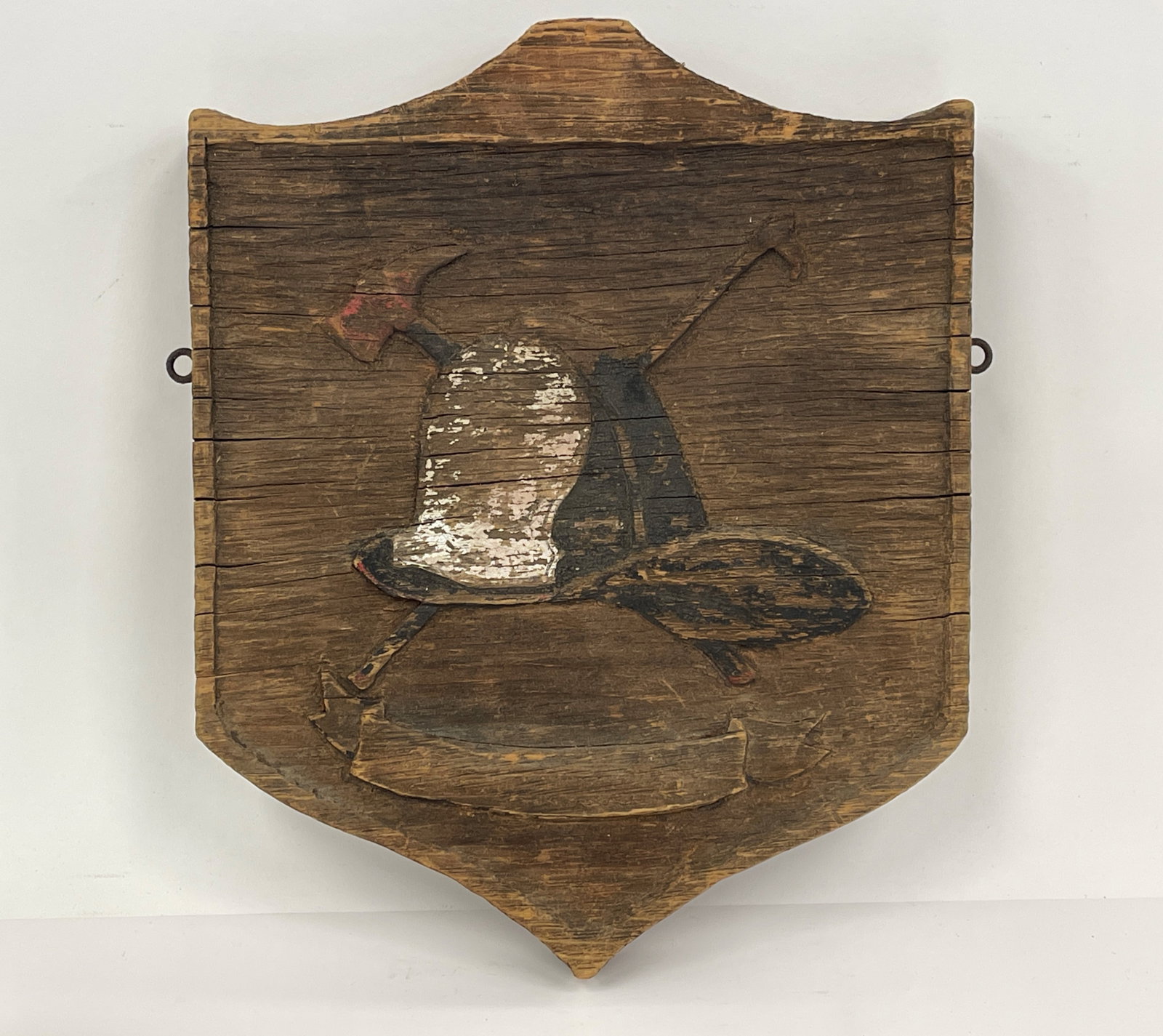 EARLY FIRE HOUSE PLAQUE: EARLY FIRE HOUSE PLAQUE WEATHERED OLD PAINT , DEPICTING " NEW YORK STYLE" FIRE HELMET WITH CROSSED AXES.
