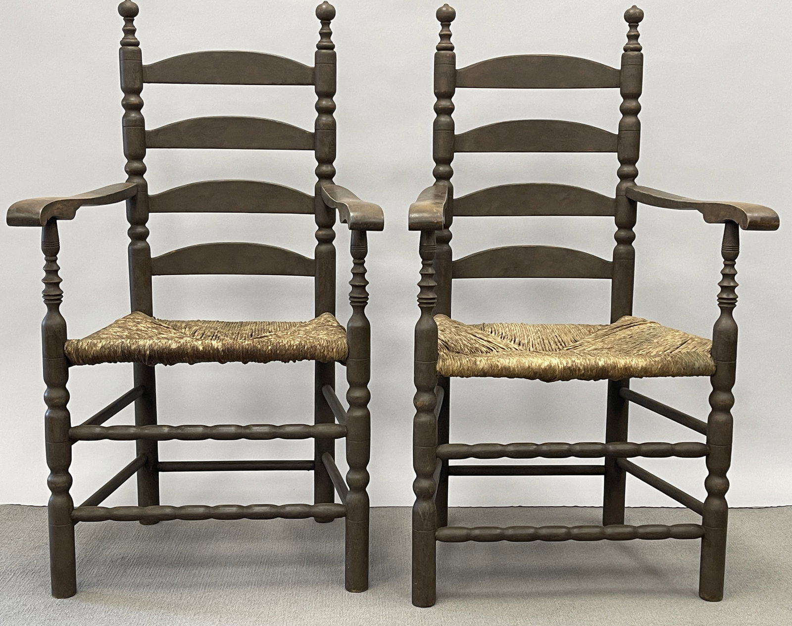 PAIR OF SPANISH BROWN 4-SLAT LADDER BACK ARMCHAIRS: PAIR OF SPANISH BROWN 4-SLAT LADDER BACK ARMCHAIRS