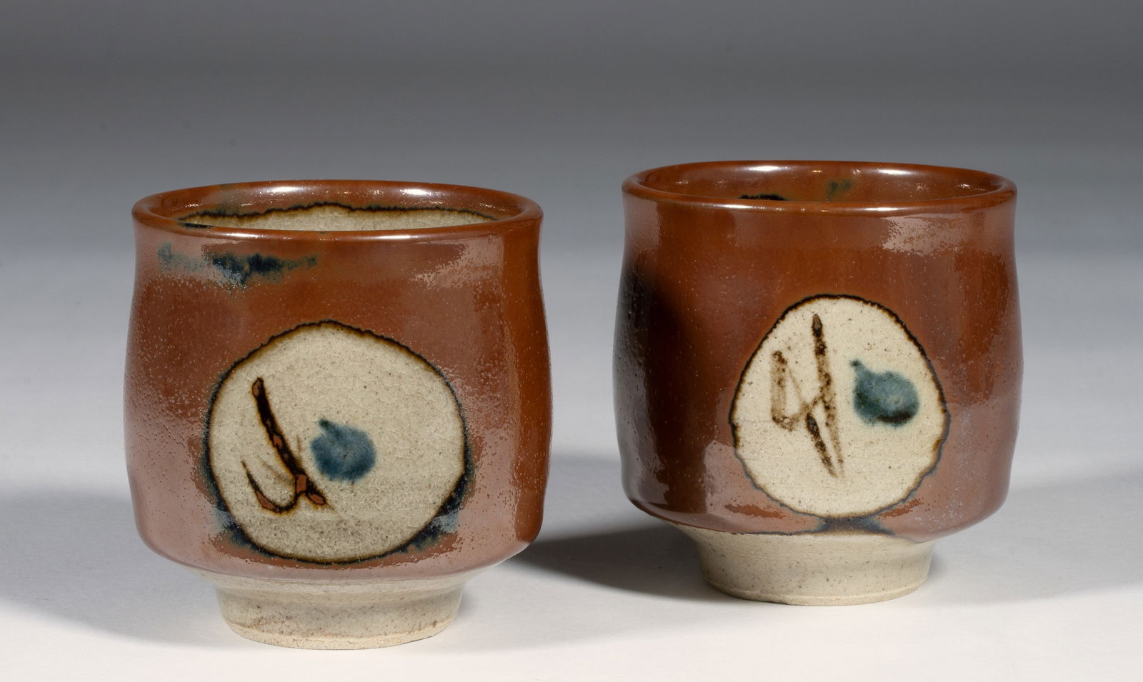 Two Japanese Tea Bowls - Shoji Hamada? - Mingei Studio Pottery: Two Japanese Mingei Japanese studio pottery Yunomi teacups possibly by or attributed to master Japanese potter Shoji Hamada (1894-1978). Glazed stoneware. Circa 1940s. Unsigned. No box. Finely crafted
