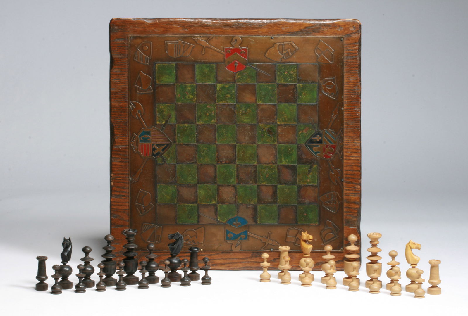 Arts & Crafts Copper & Wood Chess Set - Circa 1910: Arts and Crafts copper and woood chess set. Circa 1910. A thick oak carved wood board topped with an etched and painted copper sheet rivited to it. Decorated in the Renaissance Revival style with hera