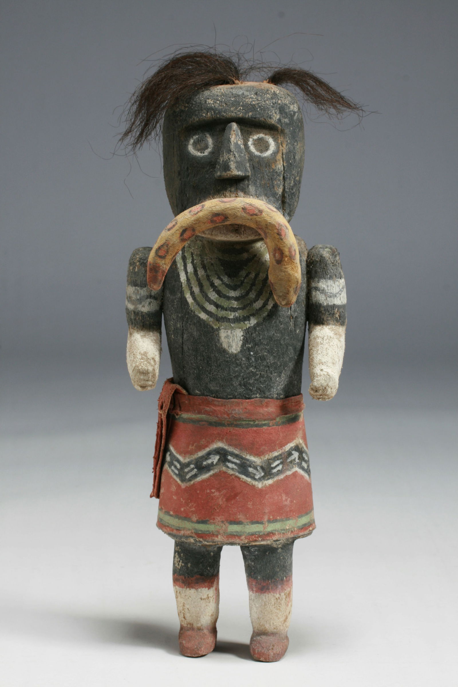 Old Hopi Snake Dancer Kachina Doll - Native American - Early 20th Century: Old and large Hopi Kachina. Early 20th Century. Carved and painted wood, painted leather and hair. A Snake Dancer Kachina - possibly Situlili (Yellow Sand Snake) or Saviki. Depicted holding a snake in