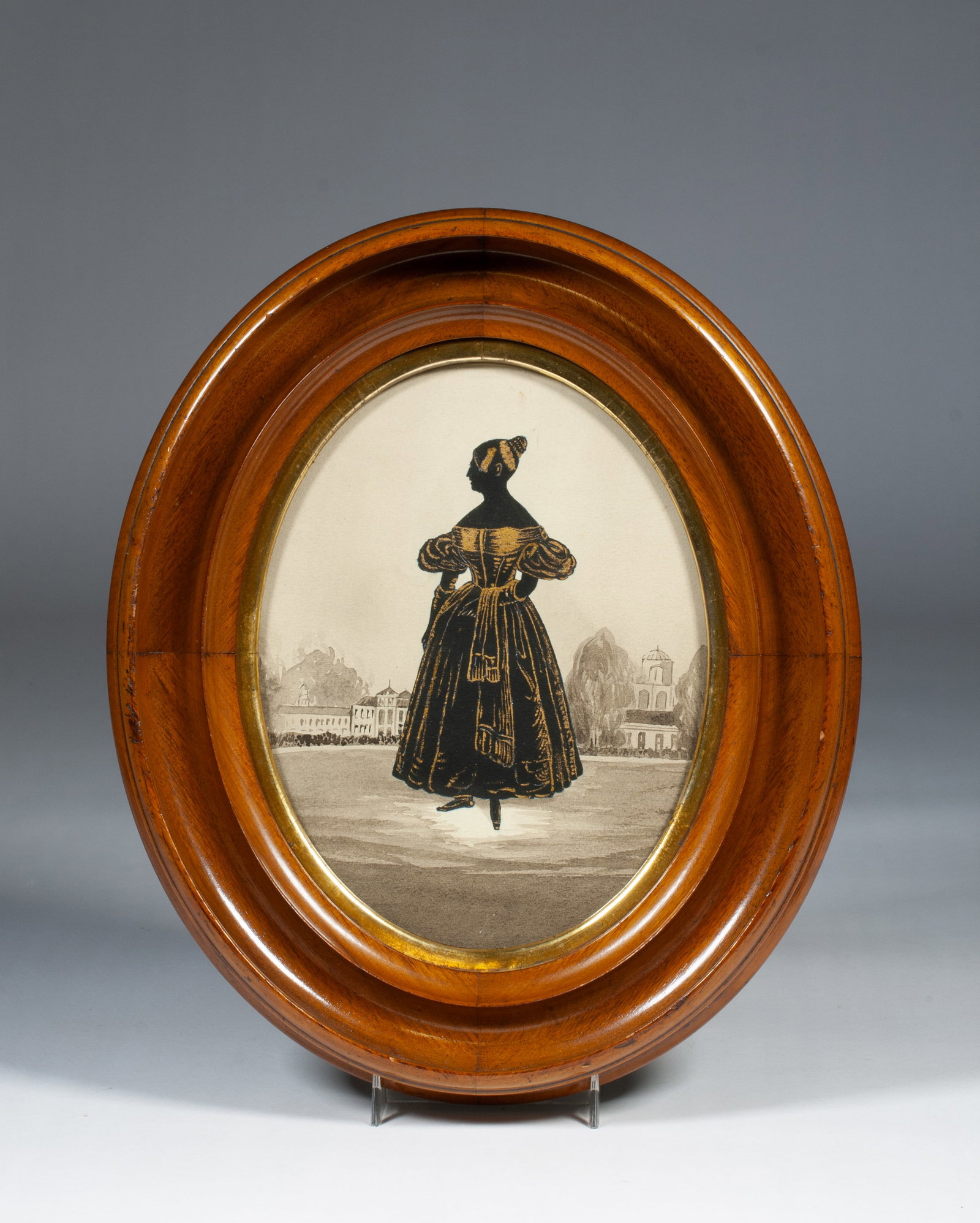 Painted Silhouette of Queen Victoria - F. Frith 1836: A painted silhouette of Queen Victoria in an oval frame. Inked handwritten label taped to the reverse, on the backing paper. The silhouette image is painted in black with gold-bronze details against a