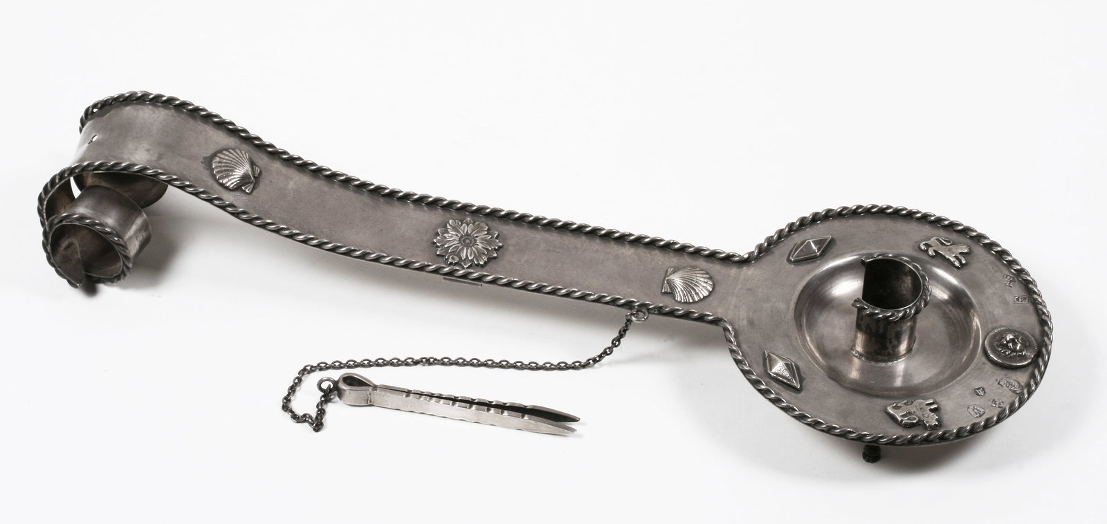 Spanish Colonial Silver Chamberstick with Hallmarks: Spanish Colonial style footed chamberstick. Tests as 800 silver. A footed bowl with a long flat handle terminating in a curled, bi-furcated end. The feet in the front are in the shape of animal legs w