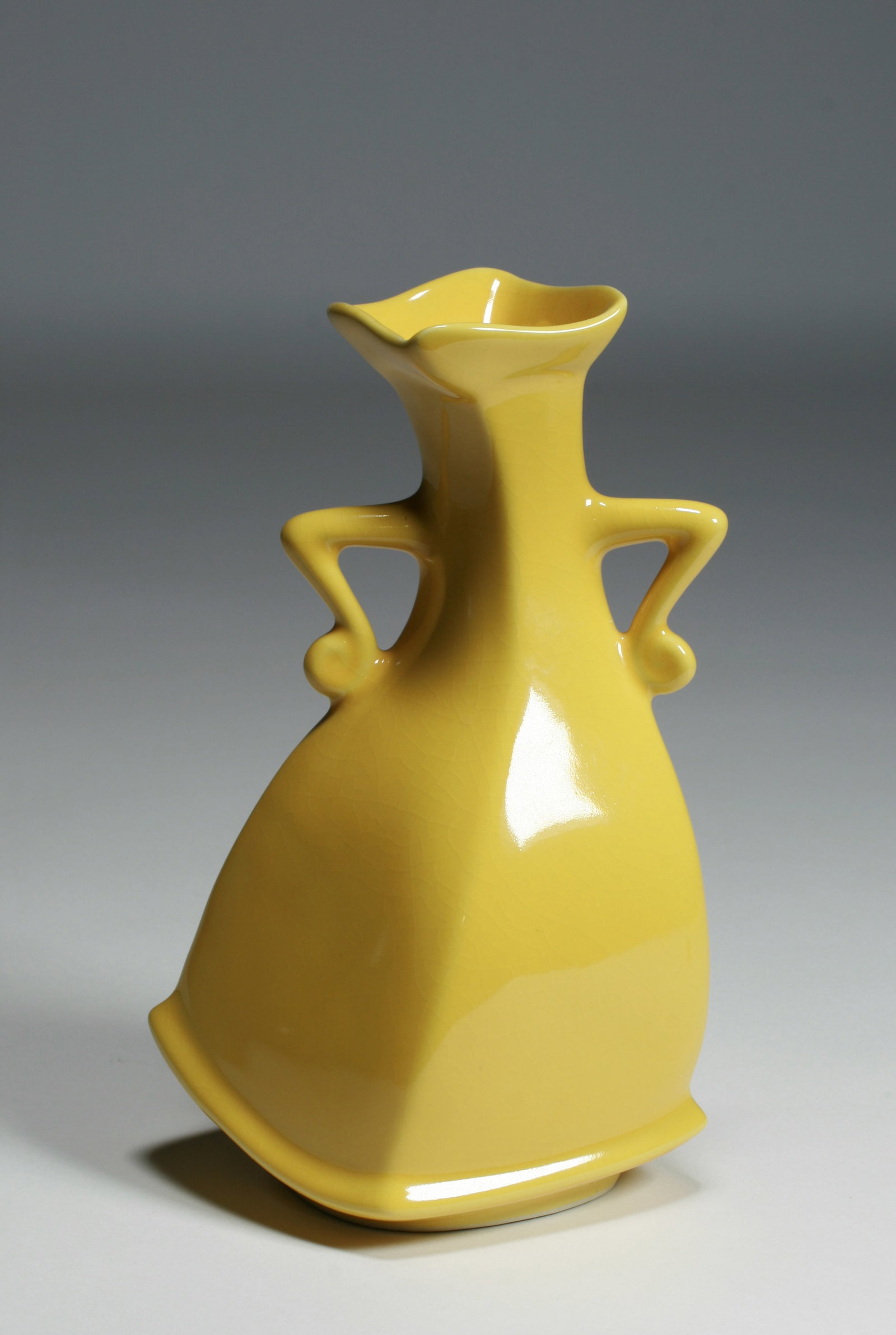 "Sassy" Art Pottery Vase by Michael Lambert: A dancing figure art pottery vase by Michael Lambert of Santa Cruz, California. From his "Sassy" series, glazed yellow with hands on her hips. Circa late 20th century and from a local estate. A large