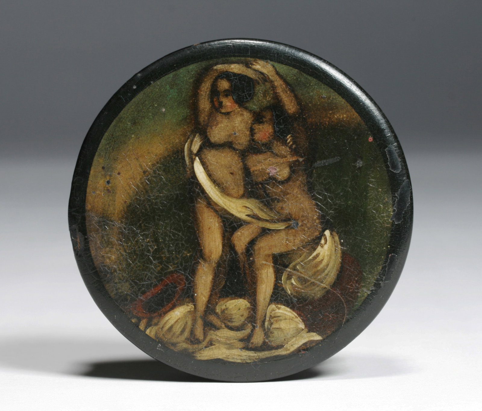 Erotic Painting of Two Women on a 19th Century Snuff Box: A 19th Century papier mache snuff box decorated with a painting of women lovers in a dark dramatic landscape. 19th century. Naive folk art manner. Diameter : 3. 3/8". ( 8.5 cm) Height : 3/4". (2 cm) C