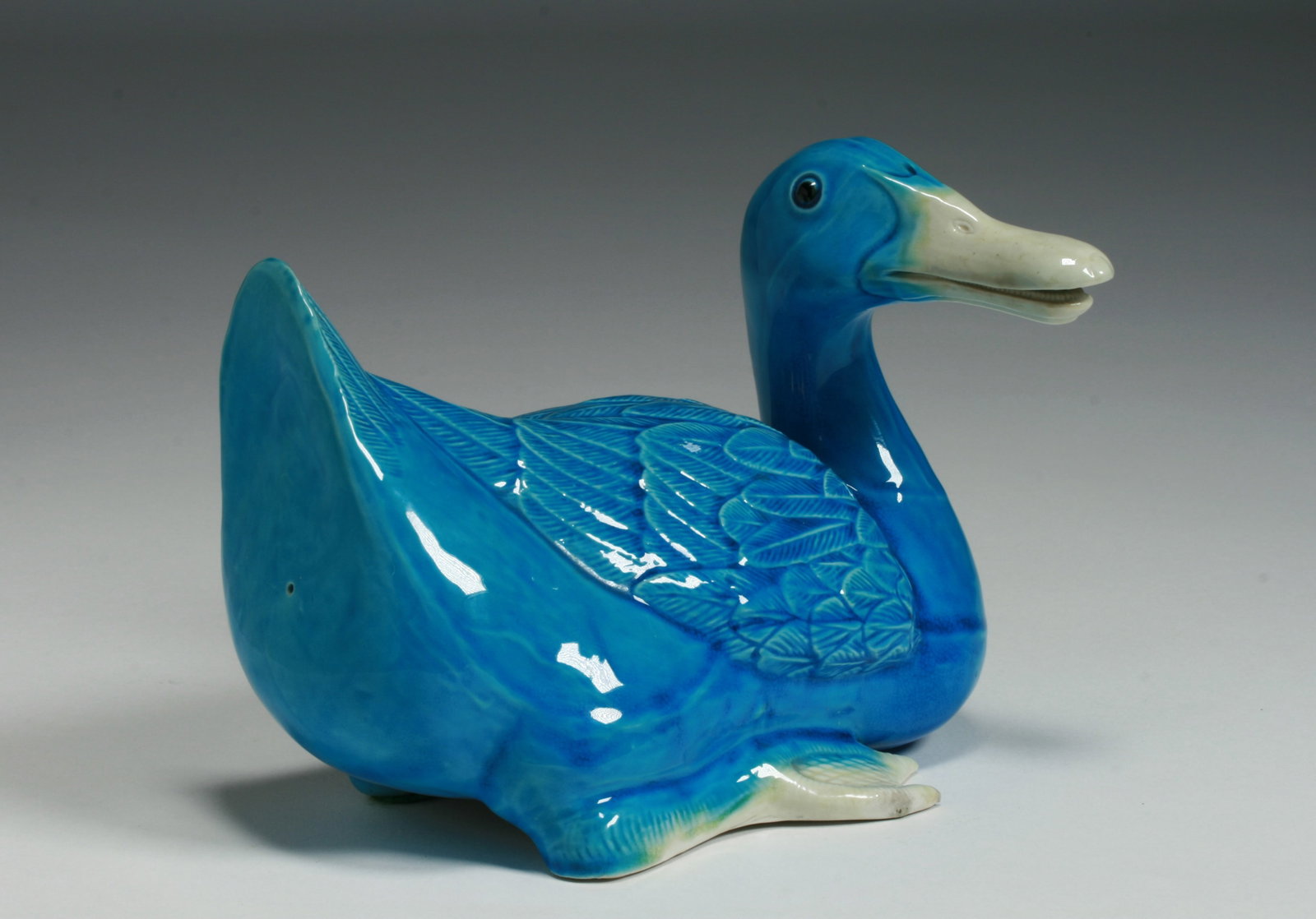 Chinese Glazed Porcelain Duck Sculpture: Antique Chinese carved and glazed porcelain sculpture of a duck. Nicely sculpted with realistic teeth in its partially opened bill. Glazed with a turquoise body and light yellow bill and feet. Height 
