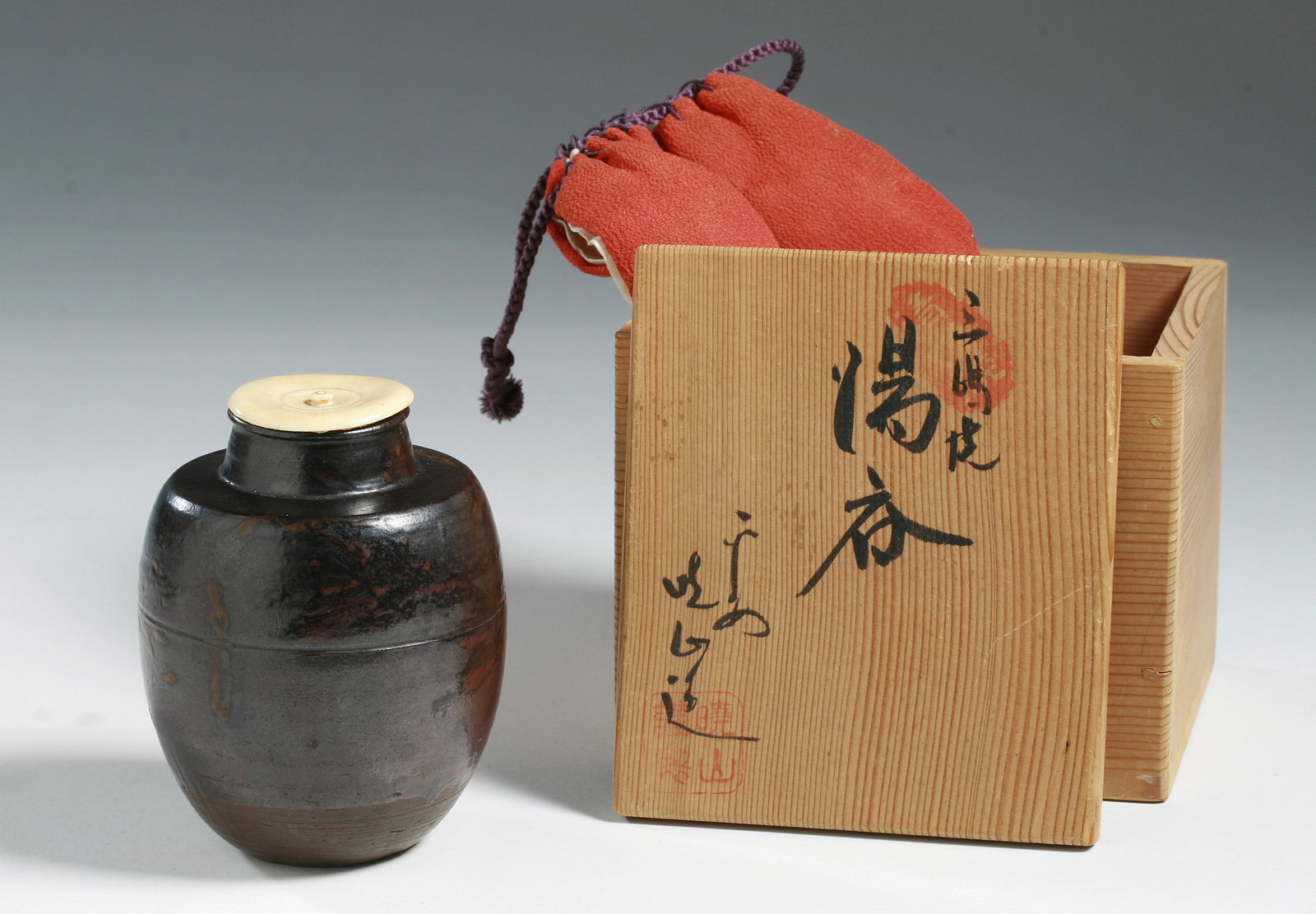 Japanese Karatsu Tea Jar Vessel - 18th Century: An early and fine Japanese Karatsu ware ceramic tea vessel or Chaire with original lid. Tokugawa Era - 18th Century. Housed in a red silk cloth bag with purple silk ties, and in a signed collectors bo