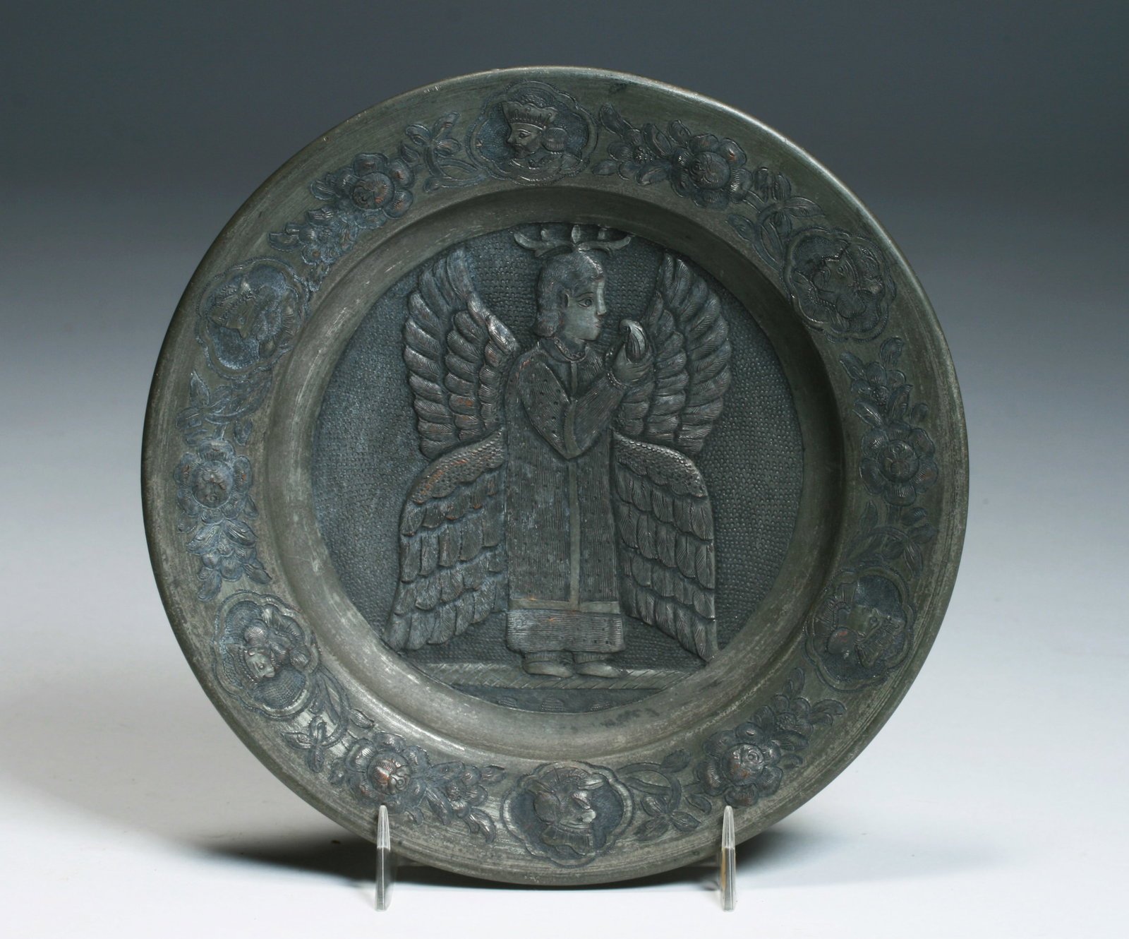 Antique Persian Engraved Copper Bowl - Qajar Dynasty: A beautiful Persian engraved & repousse copper bowl. Qajar Dynasty, Iran 18th-19th century. Finely decorated with an Angel with wings holding a fruit in the center area and the rim with a border of fl