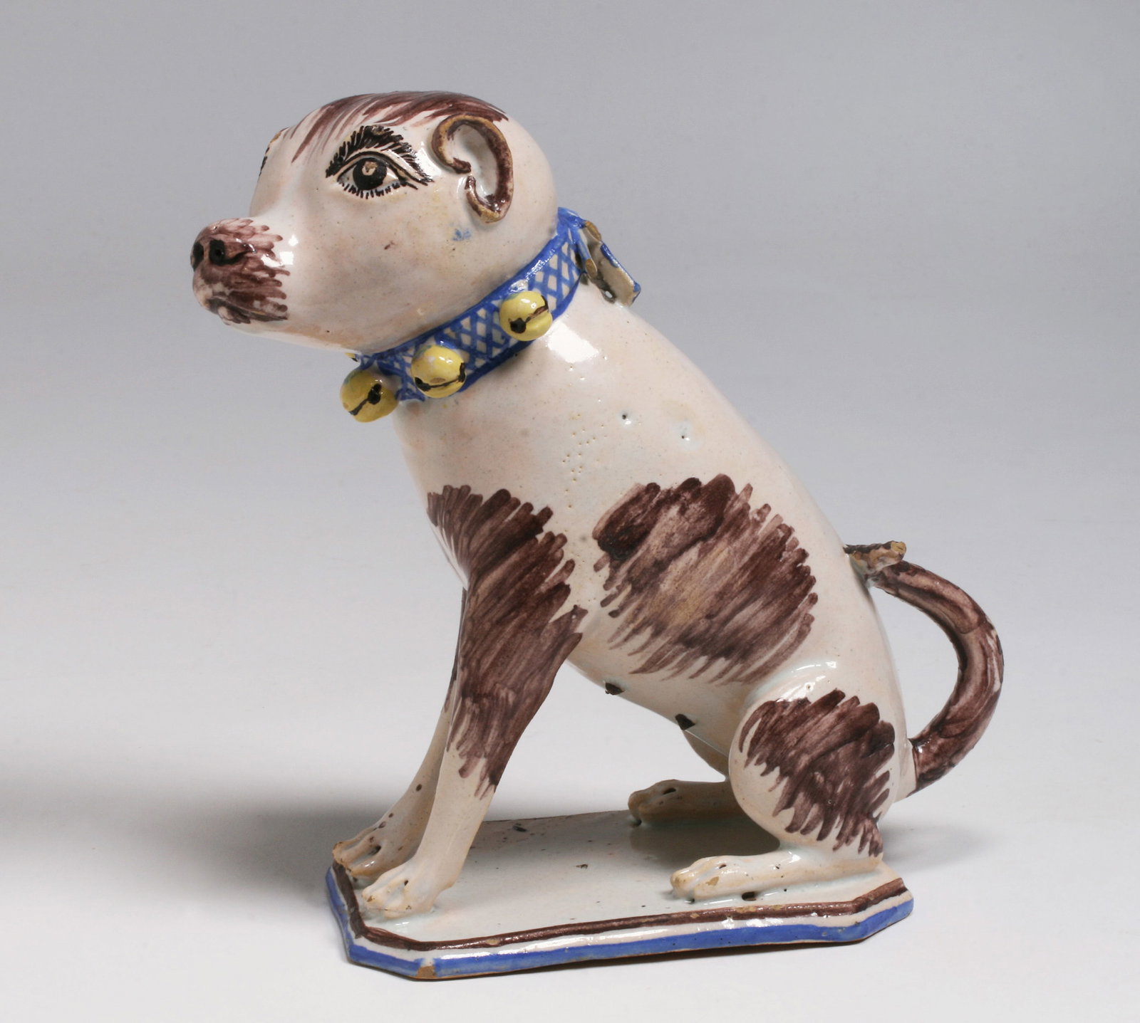 Early European Faience Pottery Dog - Naive 18th Century: A rare faience pottery model of a dog. Unsigned. Circa 1775. Attributed to the Bonn-Poppelsdorf Factory. Decorated with a milky-white faience glaze and detailed features in blue, yellow, manganese-egg