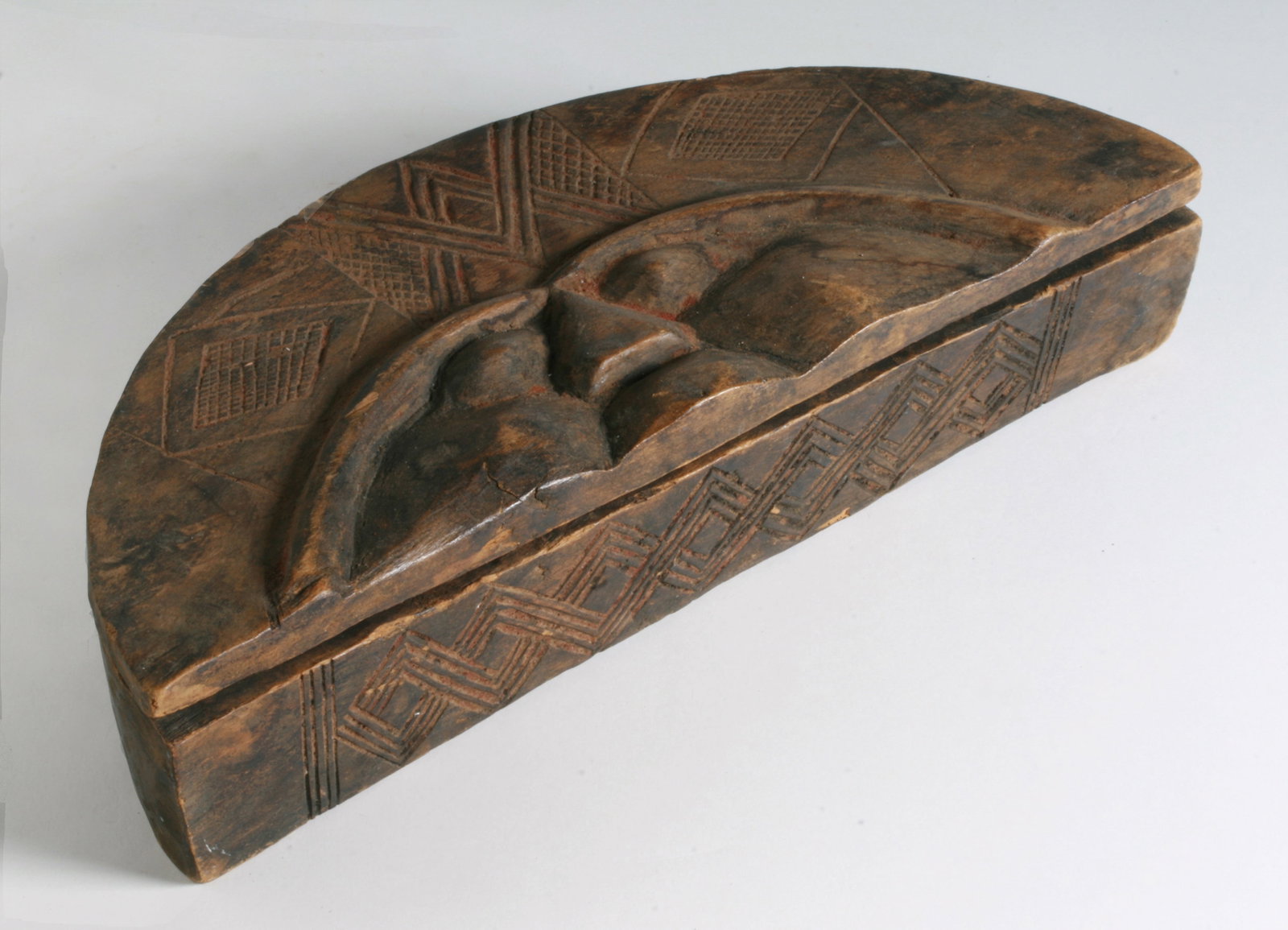 African Carved Power Box - Kuba Peoples Congo: African carved wood powder box. Kuba People, Congo. Decorated with geometric designs and a dimensional face on the lid. The interior with remnants of red powder. Mid 20th century. Width : 10 1/8" COND