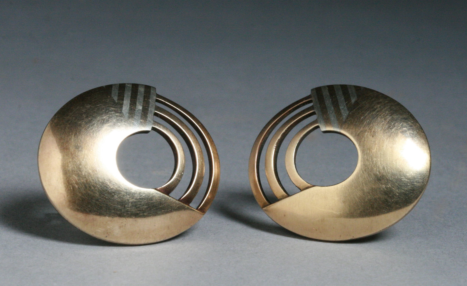 14K Gold Modernist Earrings - Signed: A fine pair of 14K yellow gold and white gold modernist clip-on earrings. 20th Century. Marked on the backs "14K" and with a copyright mark for the design and a maker's mark (see photos). Unknown make