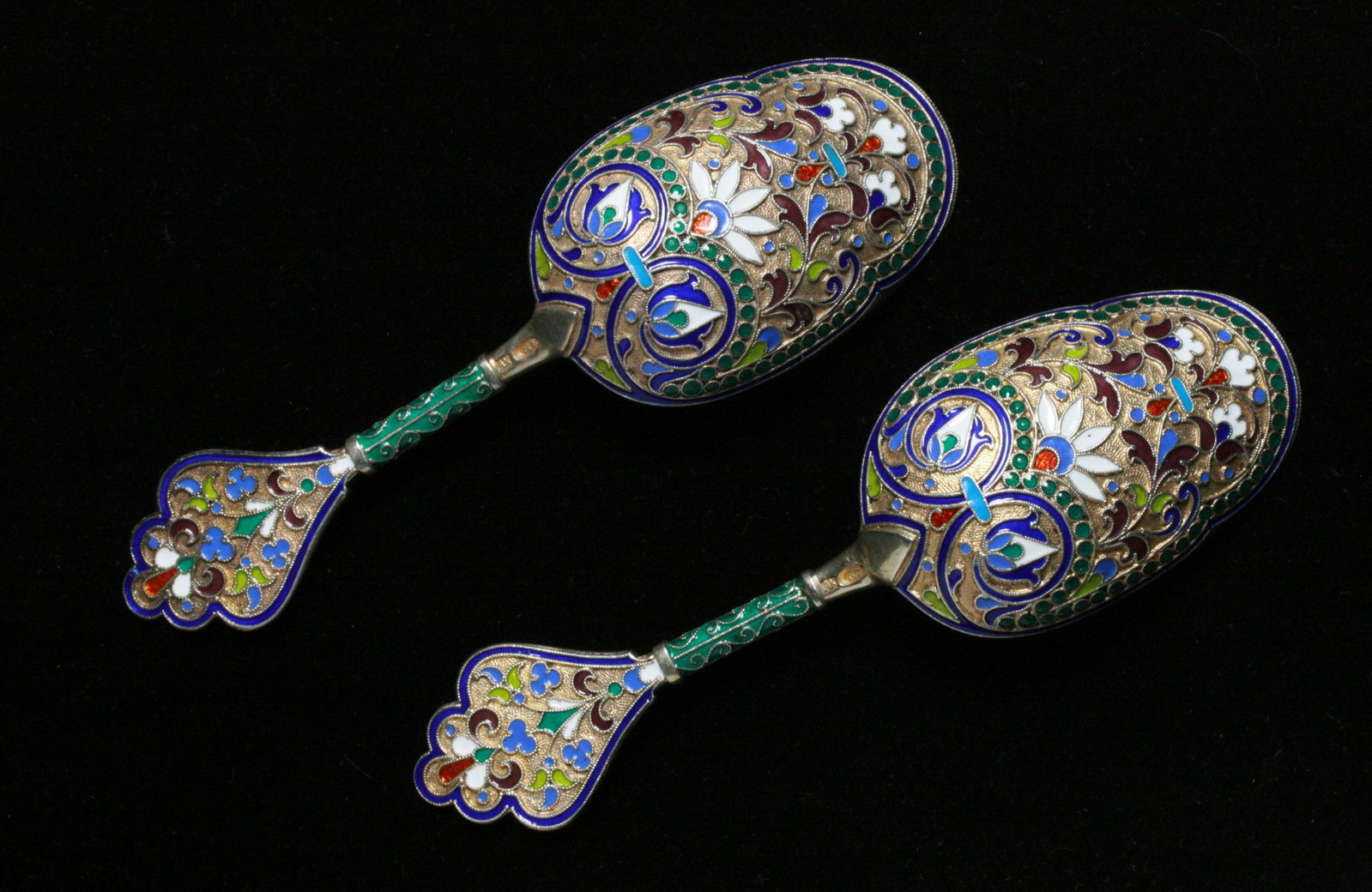 Two Russian Tea Caddy Spoons - Cloisonne Enamel on Silver - Circa 1900: A rare pair of finely enameled Russian tea caddy spoons. Late 19th century. 1880's. Hallmarks to the back of the handle (see photos). High grade 88 silver, decorated with intricate cloisonné enameled