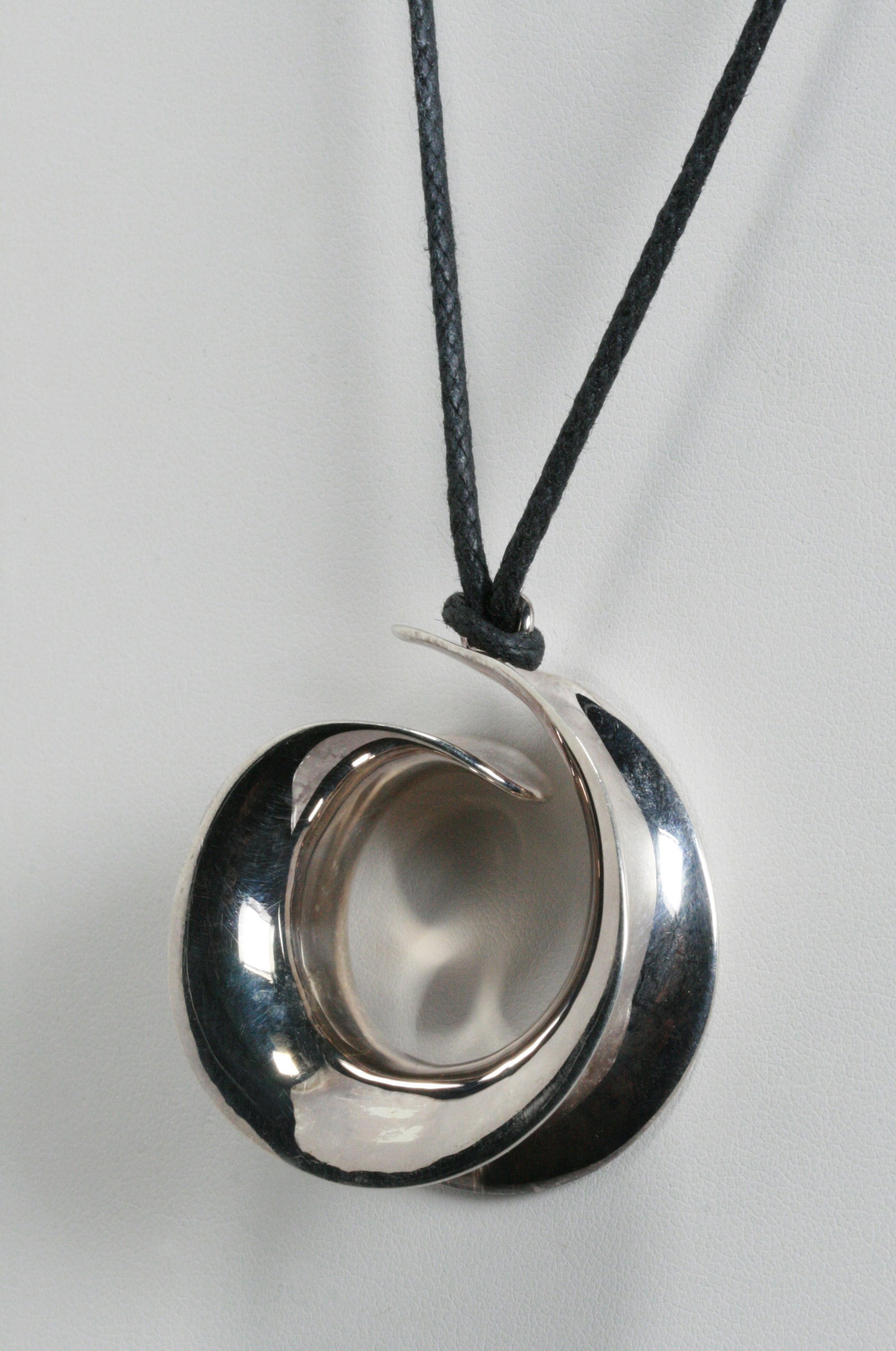 Robert Lee Morris - Modernist Abstract Sterling Pendent Necklace: An attractive sterling silver and leather necklace by Robert Lee Morris, a prominent New York City jewelry designer. Circa 1980's. Sterling pendent suspended from a fine braided leather necklace. RLM 
