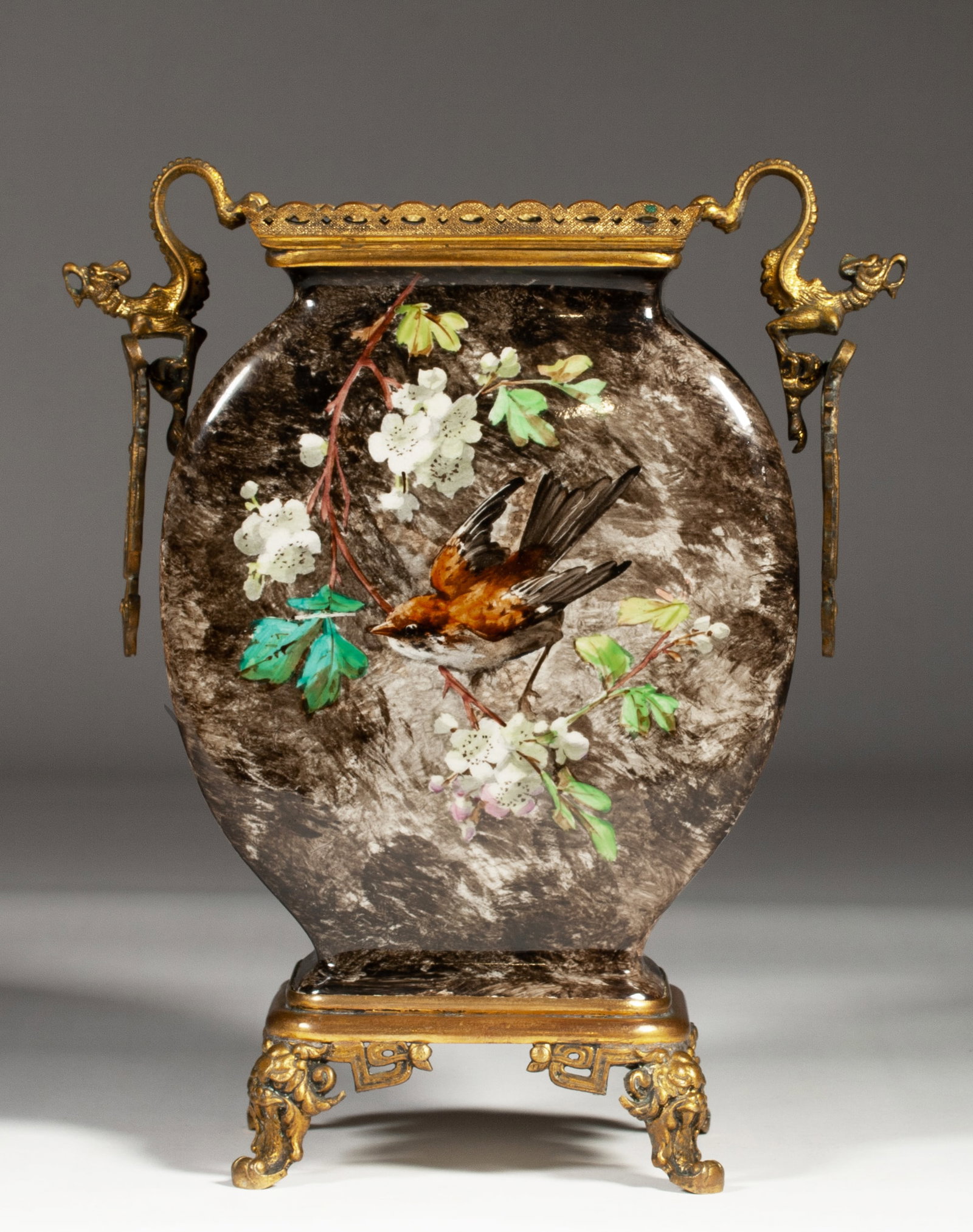 French Barbotine Impressionist Vase with Gilt Bronze Mounts - 19th C.: A fine French Impressionist hand-painted vase with gilt bronze mounts. Circa 1880. Glazed earthenware with a painted under-glaze bird and floral design and with figural Dragon design handles. Signed, 