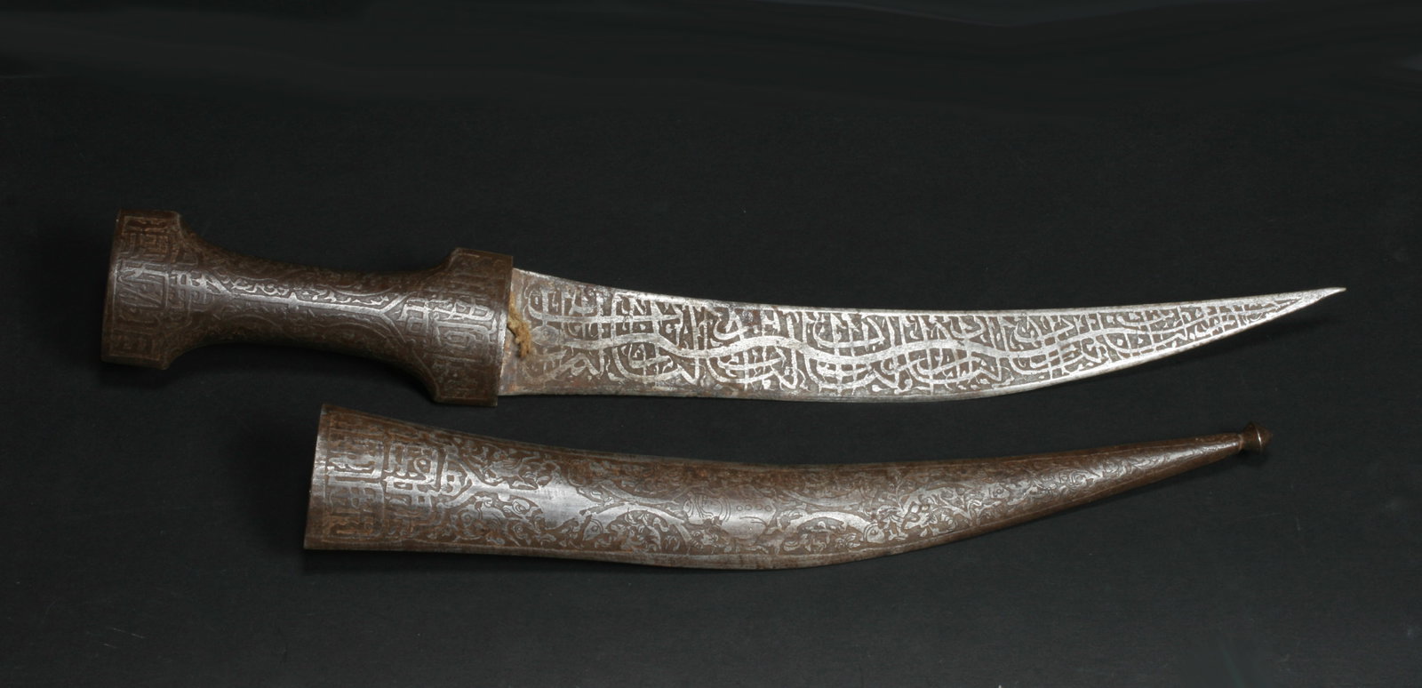 Antique Persian Iron Dagger - Knife & Sheath: An old Persian dagger and sheath with etched decoration on both. 19th century. Decorated with traditional scrollwork, Persian calligraphy and images of people and anmimals. Length (knife in sheath : 1