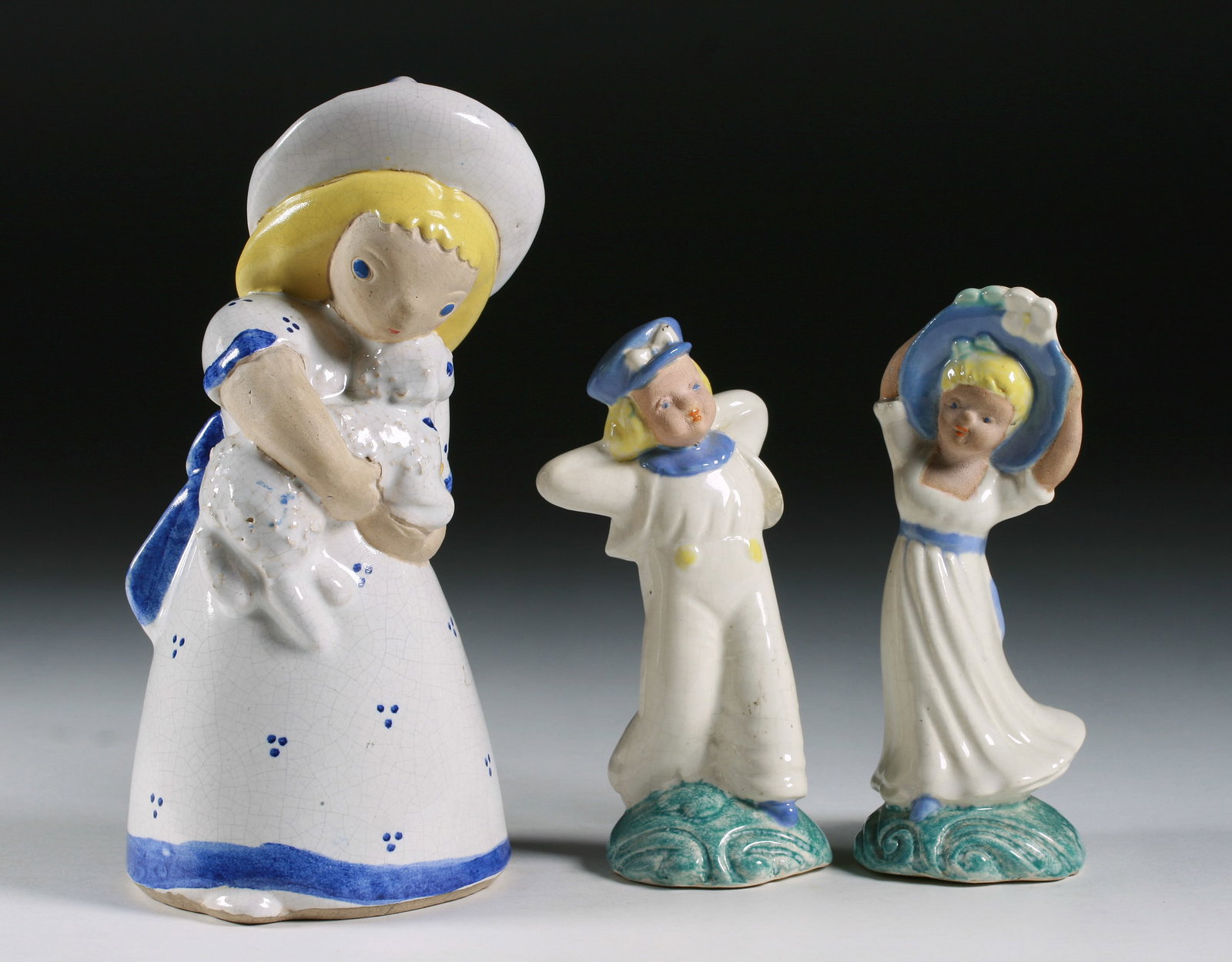 Three Art Pottery Figures by Sorcha Boru - California 1940's: A group of three glazed ceramic figures by Sorcha Boru (1900 - 2006). In the Art Deco style. California, circa 1940. Includes, "Loving Shepherdess" (7" tall) and a pair of figures of a man and woman
