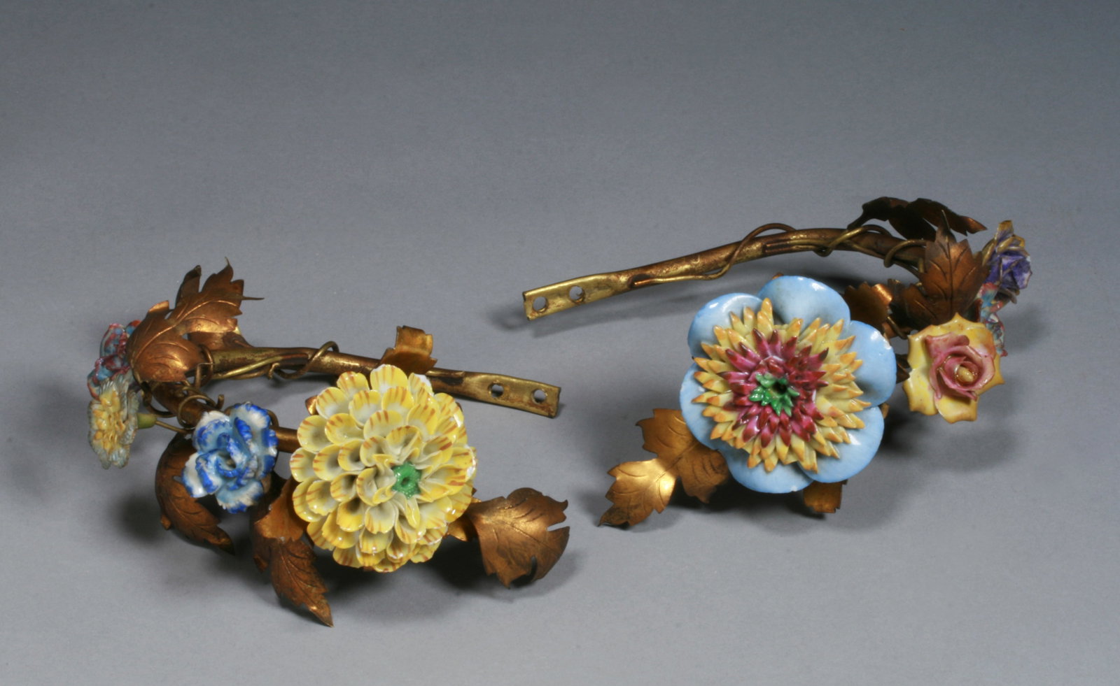 French Porcelain & Gilt Bronze Floral Curtain Dieback's - 19th C. #1: A beautiful pair of French porcelain and gilt bronze tiebacks. Four colorful sculptural flowers on each stem with ormolu leaves. Mid 19th century. Width of each : 6 1/2" Diameter of largest flowers :