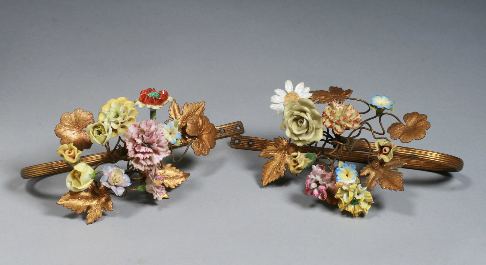 French Porcelain & Gilt Bronze Floral Curtain Tiebacks - 19th C. #2: A beautifully ornate pair of French porcelain and gilt bronze tiebacks, each with nine colorful sculptural porcelain flowers on each stem, surrounded with ormolu leaves. Mid 19th century. Width or eac