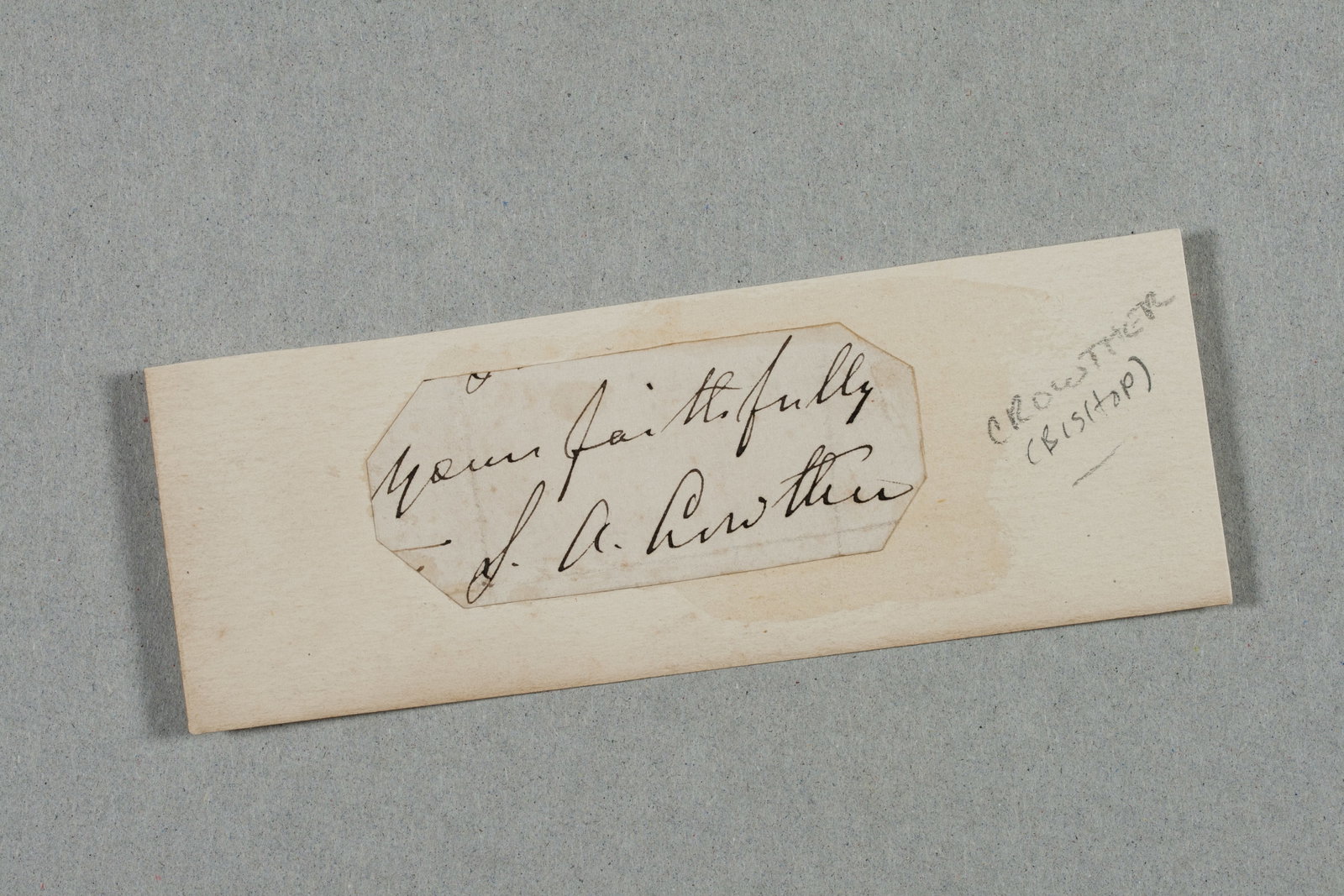 Autograph of S.A. Crowther - 19th C. Black African Slave & Bishop: Ink-signed autograph by Samuel Ajayi Crowther (1807-1891). Signed: "Yours Faithfully - S.A. Crowther" in ink on a piece of paper that is a clipped fragment of a letter. Mounted on a piece of card that