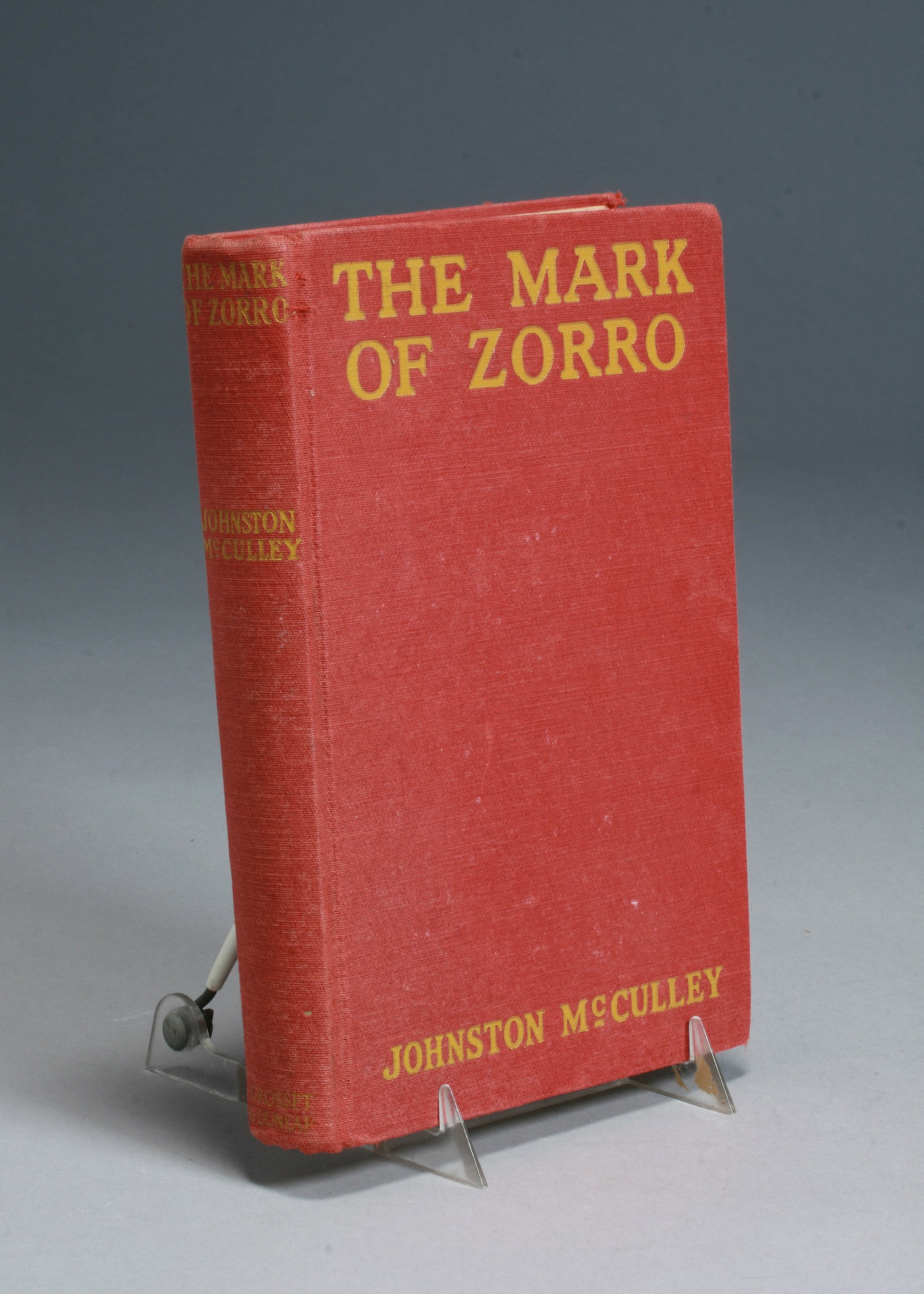 THE MARK OF ZORRO by Johnston McCulley - First Edition: THE MARK OF ZORRO by Johnston McCulley - First Edition book. Grosset & Dunlap, New York publisher. 1924. Red clothbound covers. 300 pages. SIZE : 5 1/2" x 8 1/4" x 1 1/8" CONDITION : Good condition