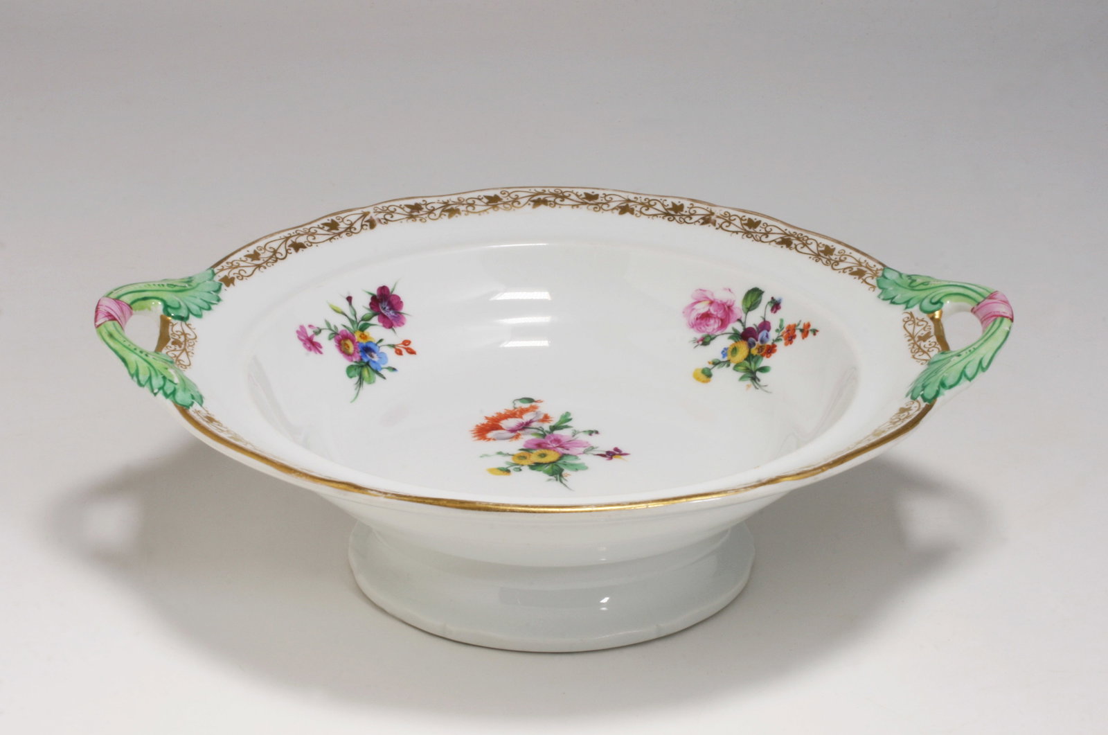 KPM Berlin Hand-Painted Porcelain Bowl - 19th Century: Hand-painted porcelain pedestal bowl with handles by the Konigliche Porzellan-Manufaktur Berlin - KPM. Featuring designs of floral sprays, elegant green leaf handles tied with pink ribbons and gold vi