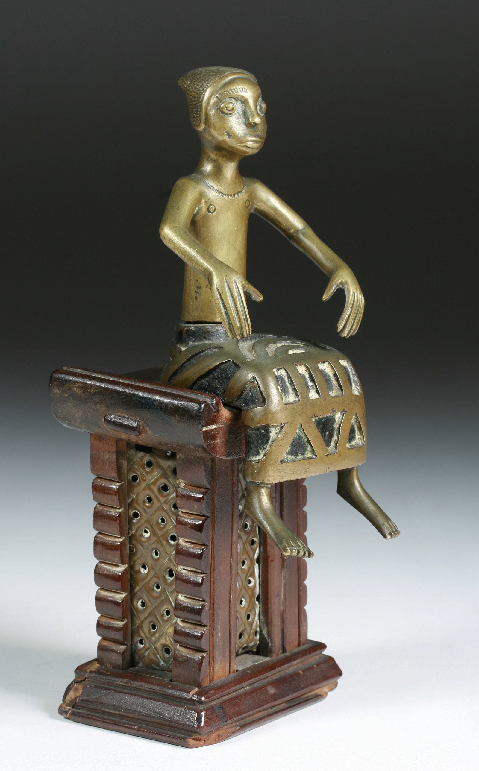 African Fon Tribal Bronze Sculpture - Figure on a Wood Throne: Fine old Fon / Benin bronze and wood sculpture of a man, a King or important personage, on a raised throne. Lost wax cast bronze, punched sheet brass and carved wood. Early 20th century. Benin, Africa
