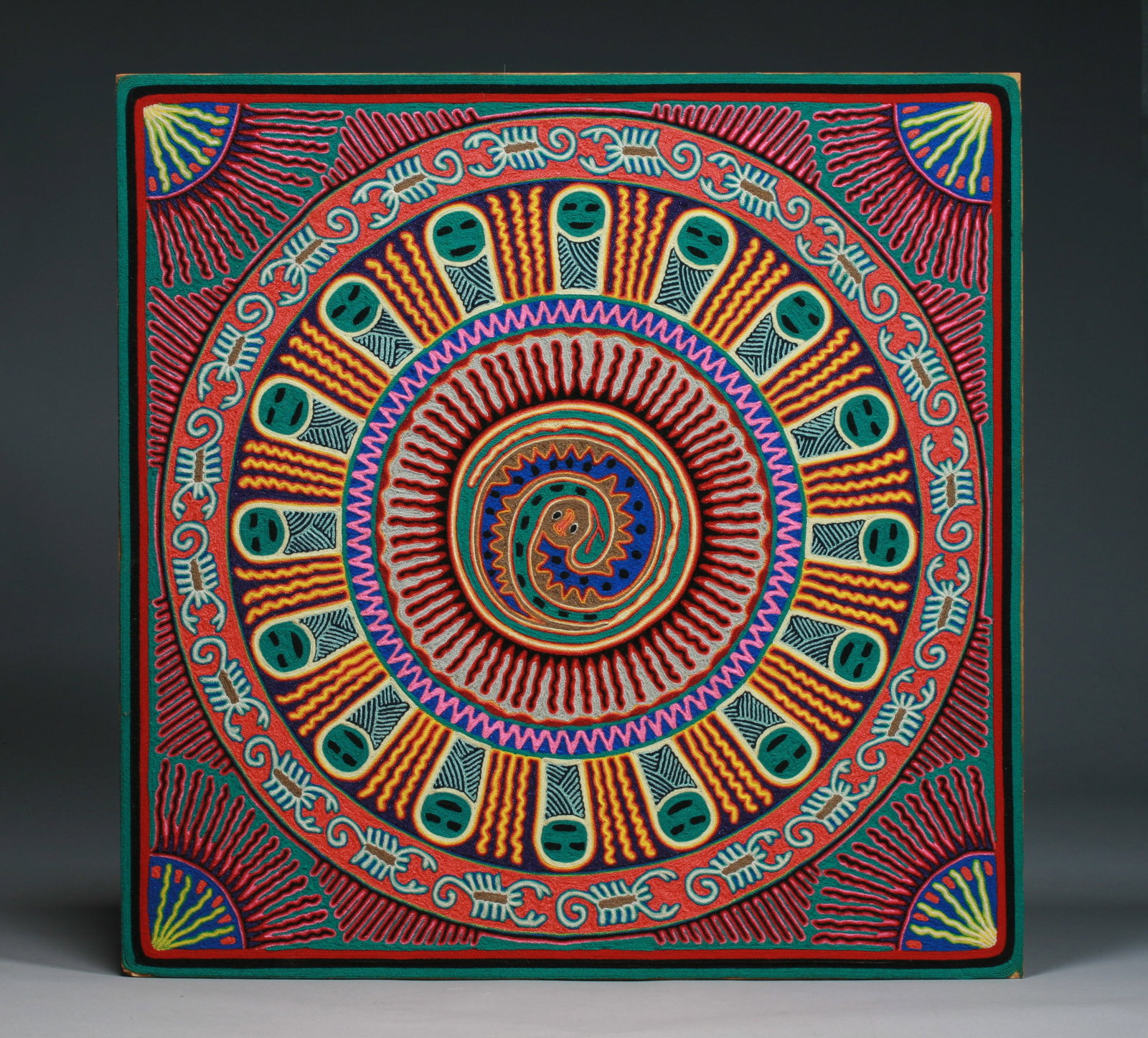 Mexican Huichol Yarn Painting by Eligio Carrillo Vicente: A fine and large Huichol yarn painting by well known Shaman and artist, Eligio Carrillo Vicente. 20th century. Colored yarn mounted with beeswax on plywood. Signed and titled "Significado" on the reve