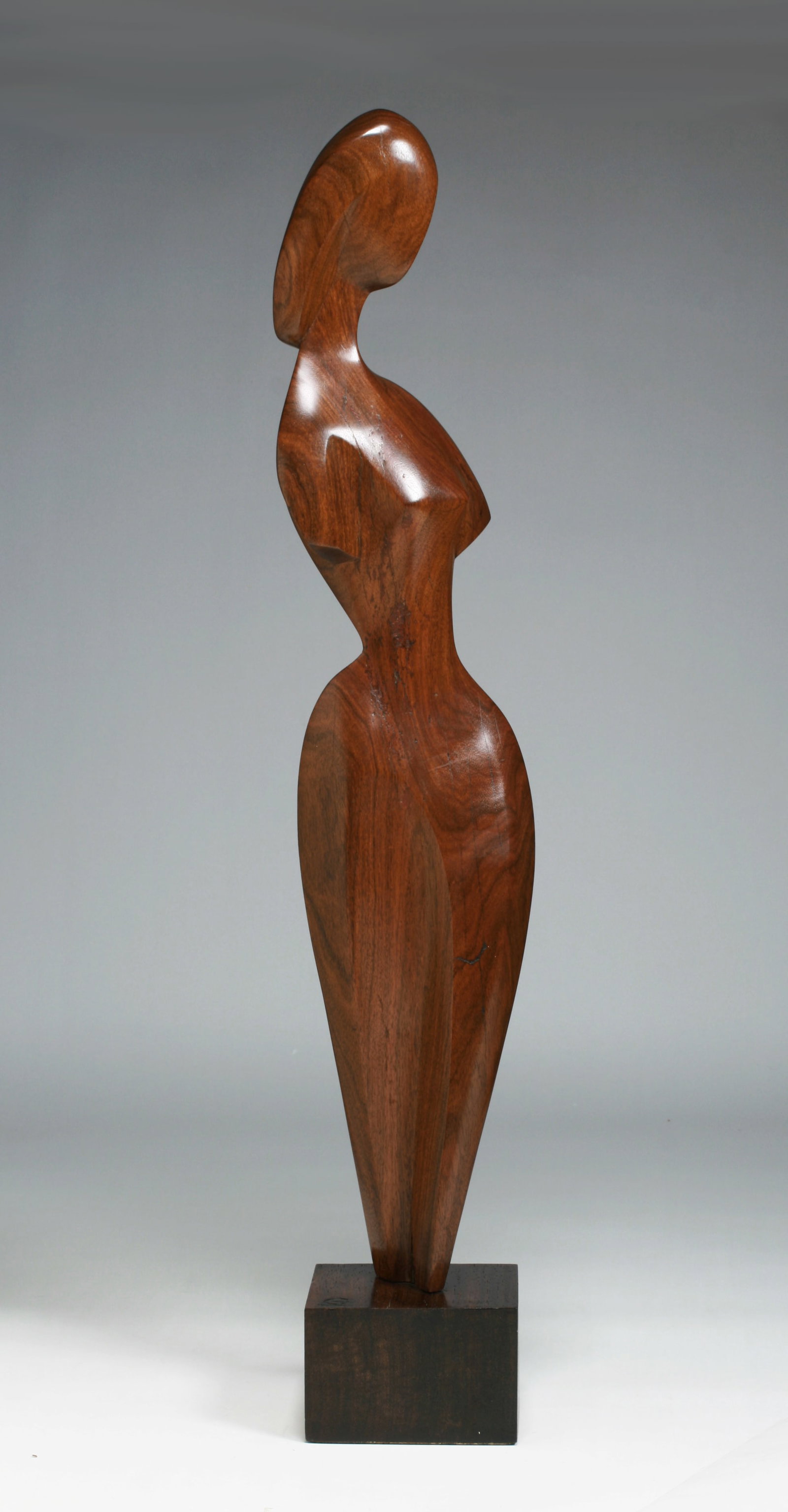Abstract Sculpture of a Woman by Joseph Goethe (1912-1993): Modern abstract carved wood sculpture of a woman, mounted on a wood base. Circa 1950. Signed on the top of the base, branded into the wood “GOETHE” under his G monogram. The underside of the