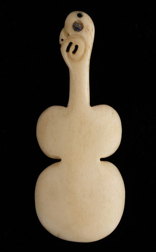 Maori ‘Kotiate’ Bone Pendant with Shell Inlay: Old Maori carved whalebone pendant or necklace ornament, with shell inlay, from New Zealand. Early 20th century (or earlier). Carved in the shape of the traditional Maori war club known as a ‘Kotiat