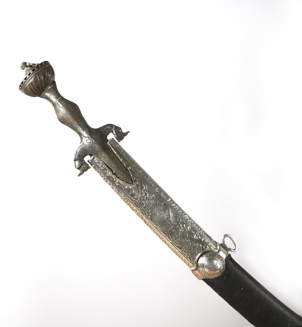 A Mughal Handle Sword 18th - 19th century: with damask steel blade, lobbed cartouches and makers mark stamp. The characteristic disc-hilt and knuckle bow made of damask steel and engraved. Sheath is not original. In sheath approx. 95 cm Out of