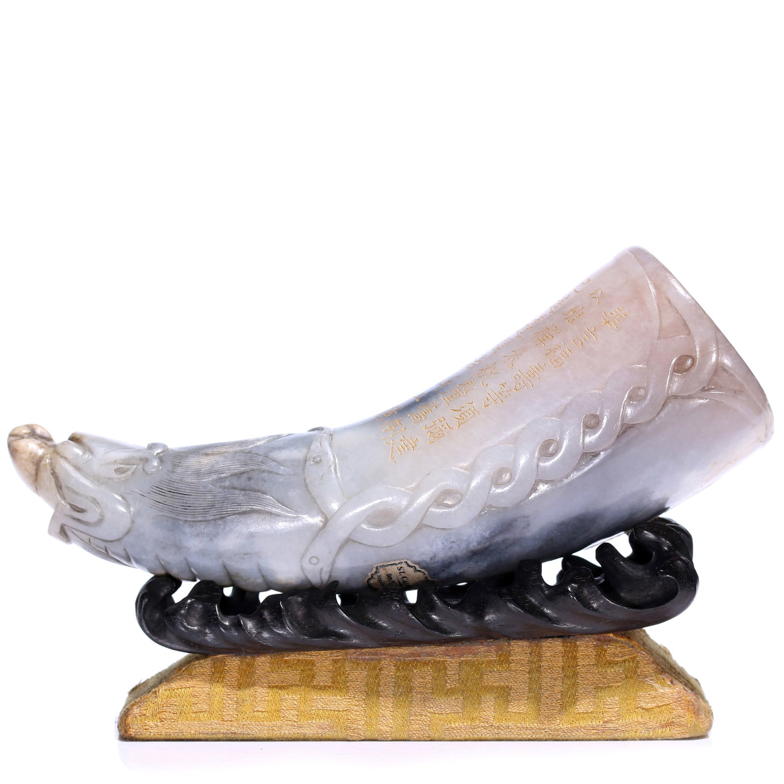 A Chinese Qinghua Jade Carved Horn-shaped Ornament Decorated In Words With Stand: L 14 cm, D 4.6 cm, height including accessories 10 cm.