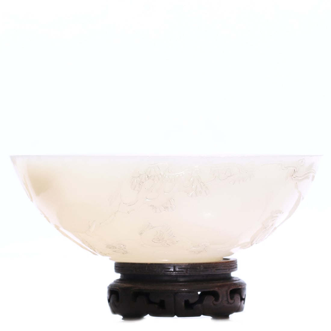 A Chinese White Jade Carved Bowl With Stand: H 4 cm, D 10.5 cm, height including accessories 6 cm.