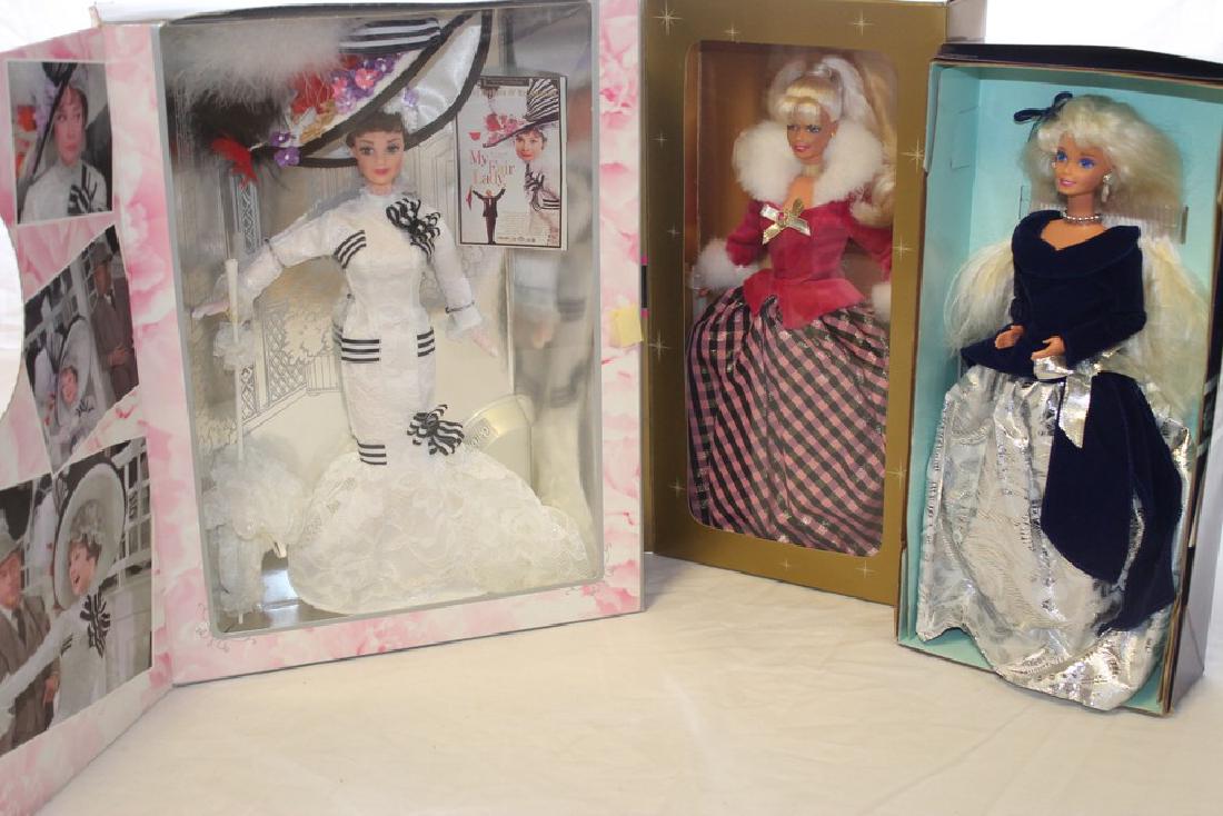 Lot of 3 Barbie dolls: My Fair Lady Eliza Doolittle Barbie Doll, Avon Special Edition Winter Rhapsody Barbie, and Avon Special Edition Winter Velvet Barbie.
