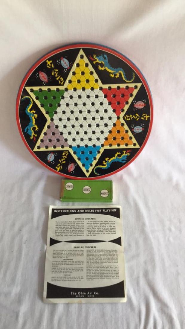 Vintage Chinese checkers metal tin with marbles: Vintage Chinese checkers metal tin with marbles and original instructions. Slight dent on top. 12 1/2" diameter 11 Good