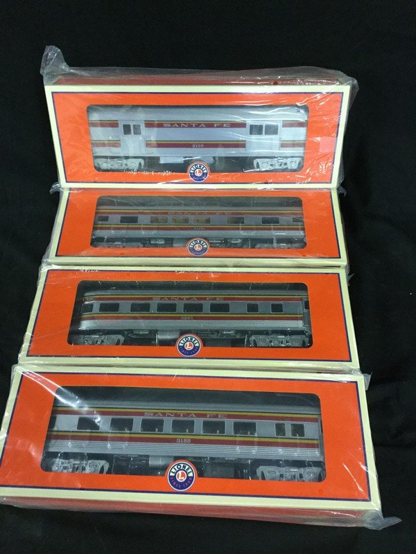 Four Lionel train cars and graduated trestle set (1 of 3)