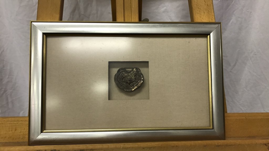 Silver locket in frame: Silver locket with Victorian design in frame frame 14"x9" sight size 3"x3"