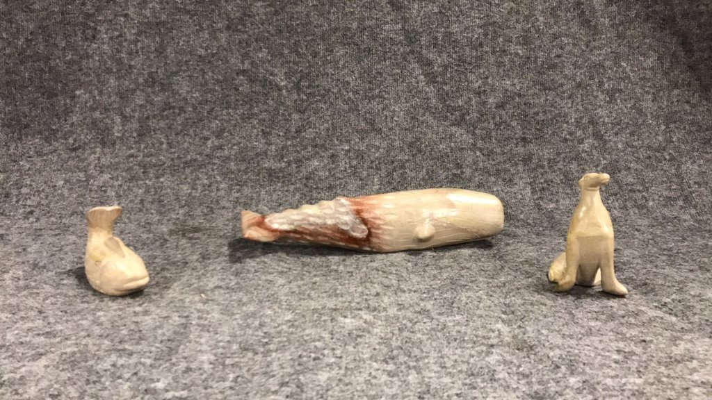 Three carved soapstone sea animals: Three carved soapstone sea animals Fish 5.5" long Seal 5" tall Sperm Whale 14" long signed JOM 1978