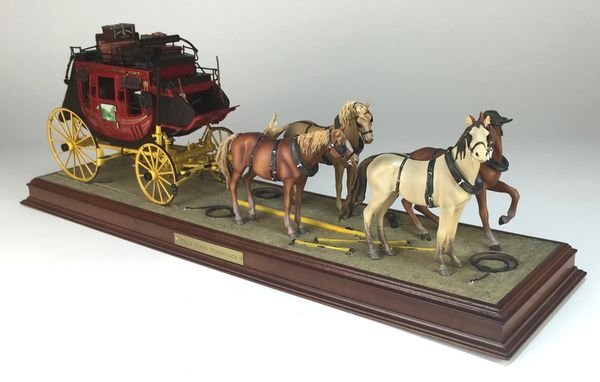 Franklin Mint Wells Fargo Four-Horse Team Diorama: What a scene this sets: the cargo-heavy stagecoach is at rest, its drivers and passengers stopping perhaps at a roadside inn, its horses relishing a moment to relax. Created at a 1:16 scale, this dior