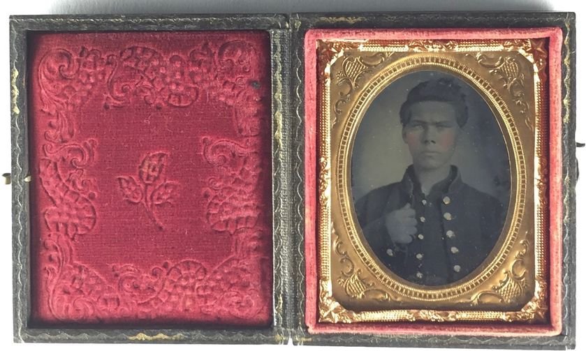 Antique Military Soldier Photograph in Leather Case: Small 19th century photograph of the same young man in a military uniform, whose name was William according to the label pinned inside the boxed frame, which was called a union case in its day. The ca