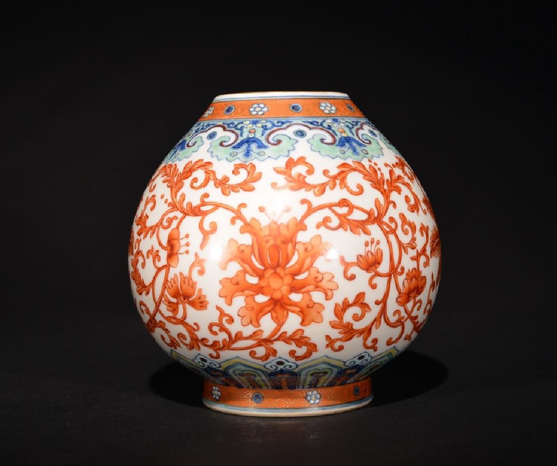 A DOUCAI WASHER , Qing Dynasty: The washer is wide cylinder-shaped and the exterior is decorated with numerous orange lotus designs. There is a marked seal on the base of the washer. Size: 5 3/8 in. (13.6 cm) tall, 5 3/8 in. (13.6 c