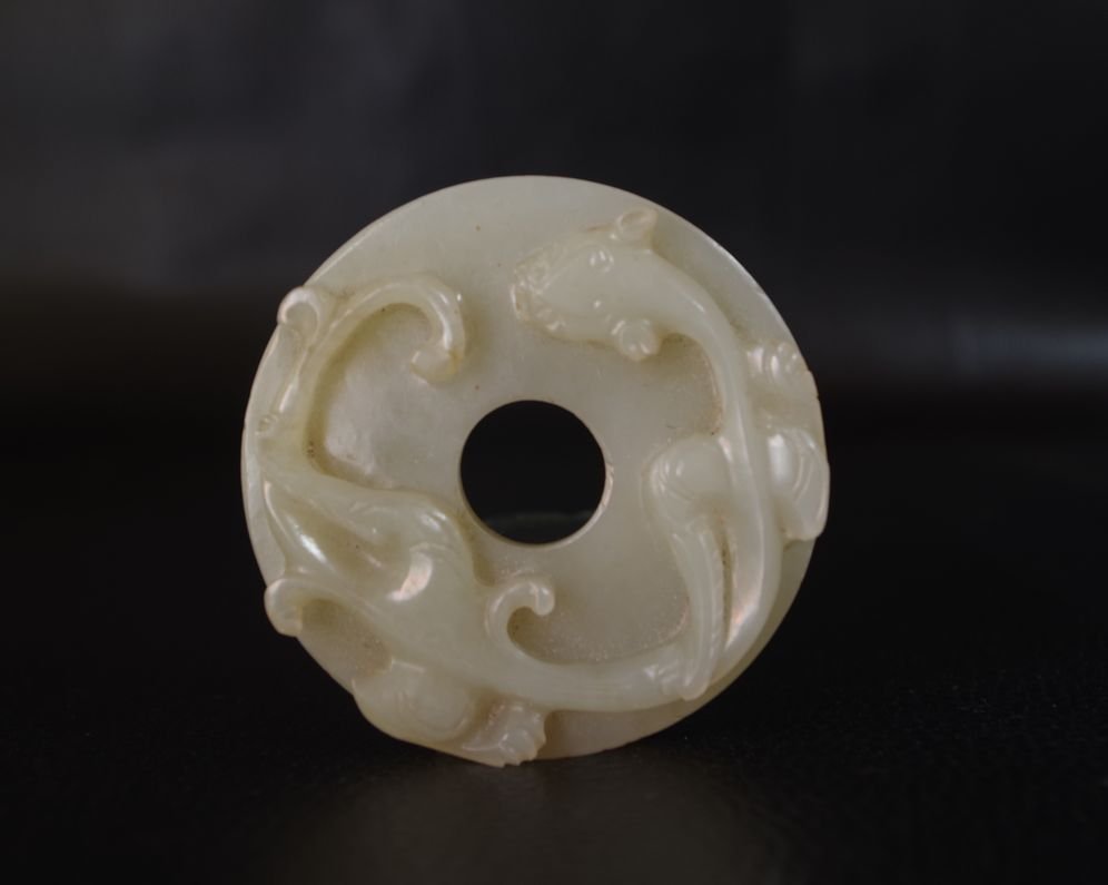 A CHINESE UNEARTHED WHITE JADE  DISC (1 of 7)