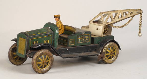 1930s Tipp & Co tinplate clockwork crane: A German Clockwork Tinplate 5-Ton crane by Tipp & Co., lithographed in green and gilt, with simulated Dunlop Cord tyres, tinplate driver, `TCO` trademark to bonnet; together with a tinplate 1950, Pont