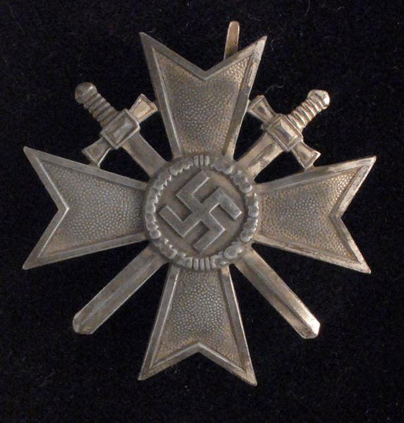 1939 War Merit Cross 1st Class With Crossed Swords: Maker marked '3' within a square, with a vertical broad flat pin and catch. Significant loss of the original silver finish, otherwise in good condition.