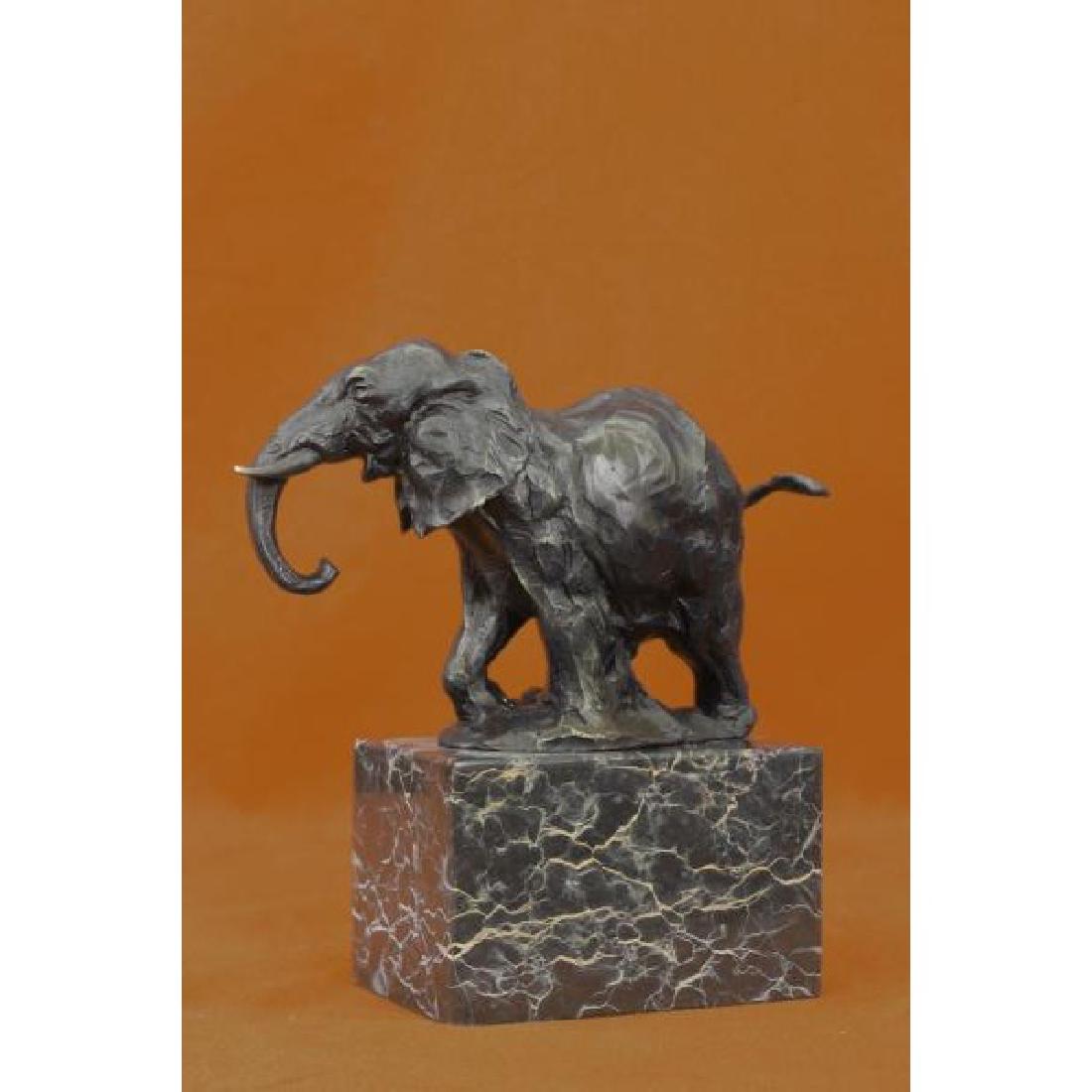 Elephant Bronze Sculpture on Marble Base Statue: The elephant can be envisioned tracking slowly and majestically across the ceaseless dryness of a plain in search of a watering hole or the shade of trees. He pulls his trunk upwards. He pulls his tru