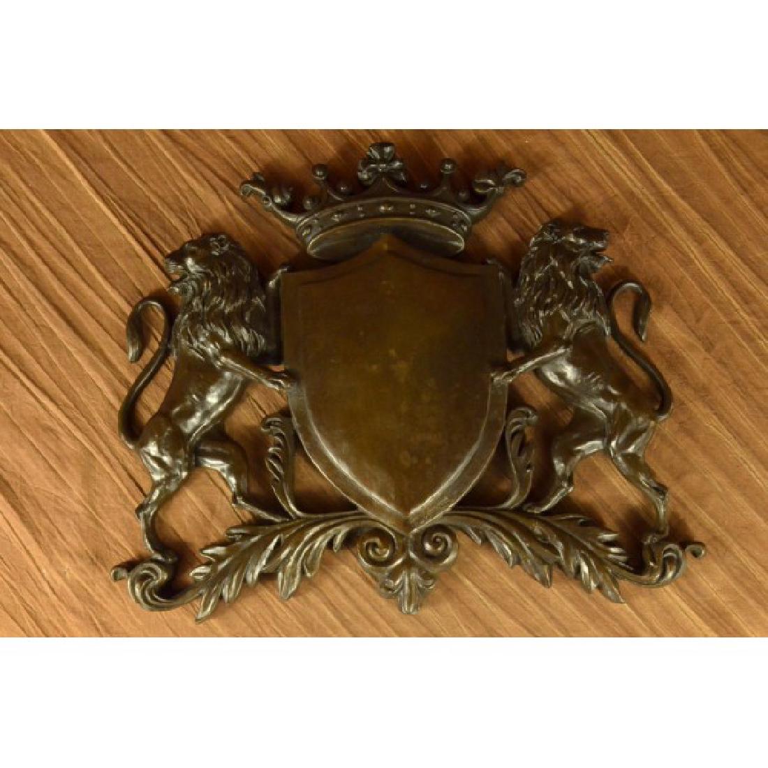 Traditional Crest Power Behind Shield Bronze Sculpture: This amazing piece that would go lovely as a family traditional crest describes the power behind a shield and two lions. They were use as a way of protection from all weapons, enemies and evil, etc. T