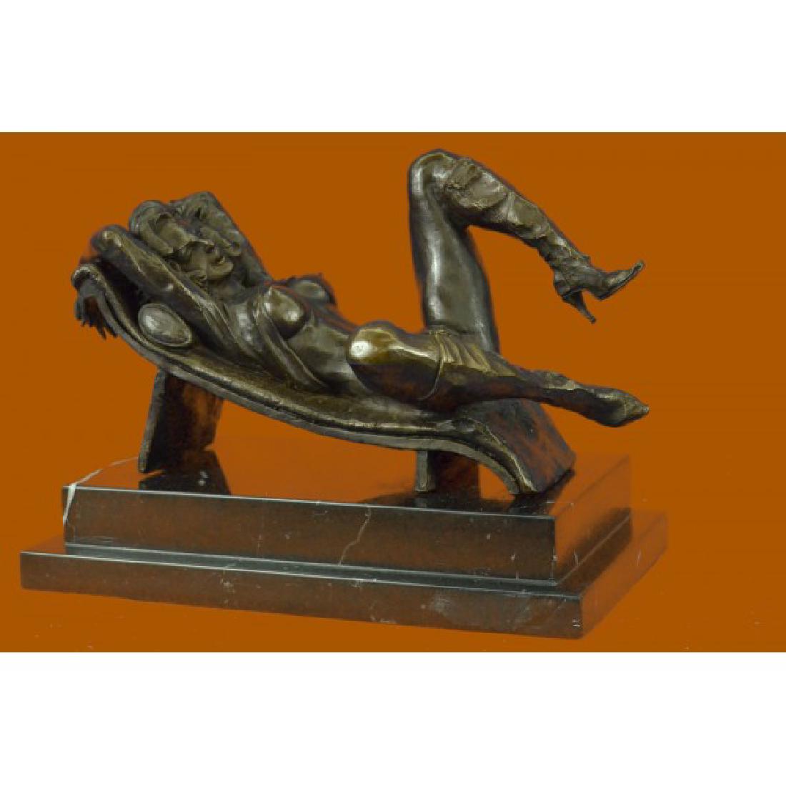Erotic Nude Sexy Vixen Bronze Sculpture: Here lays a naked vixen. She leans up against a sofa bed and slowly leans back. Her hand slides up her body and slowly lifts her shirt over her breasts, revealing her hard nipples. With her hand she c
