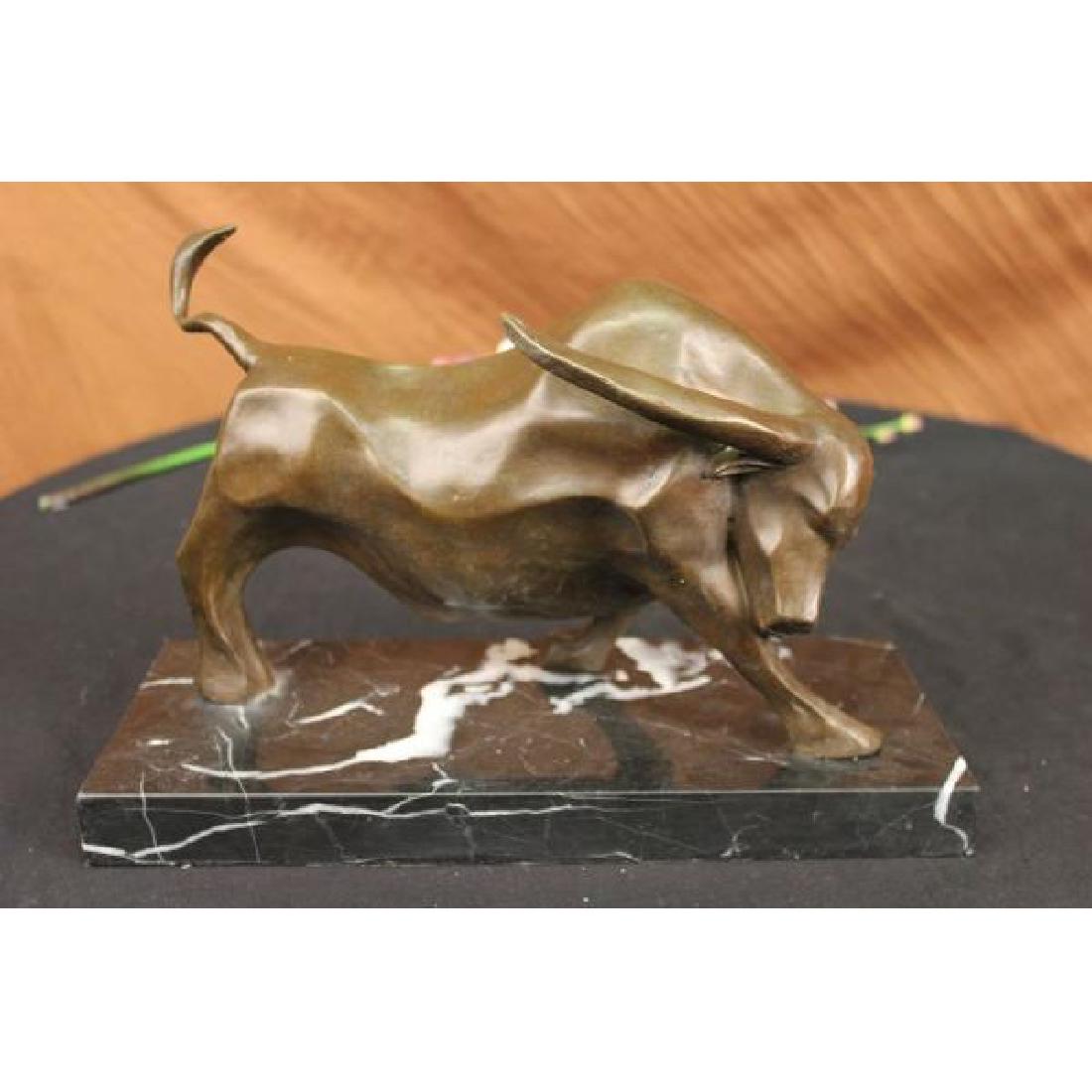 Modern Art Bull Bronze Sculpture on Marble Base: This magnificent sculpture is of a charging bull with his head down, his nostrils' flared and his muscles tightened he stomps the ground before him, releasing a vibrating grunt, he smells the ground b